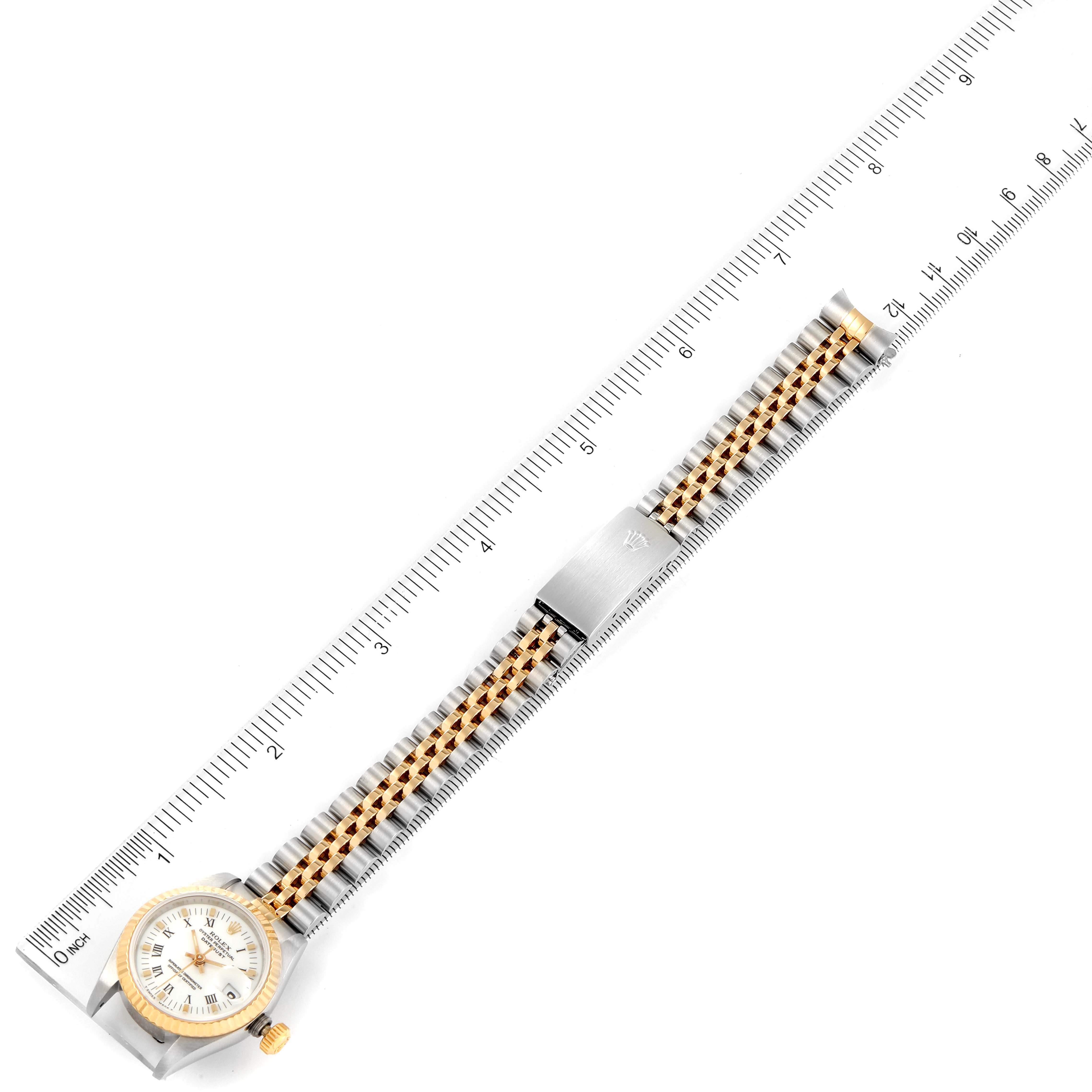 The Rolex Datejust 69173 Women's Steel and Gold (two tone) White Dial 69173 Women's Steel and Gold (two tone) White Dial watch is shown from a top-down angle with its dial, bracelet, and clasp visible alongside a measuring ruler.