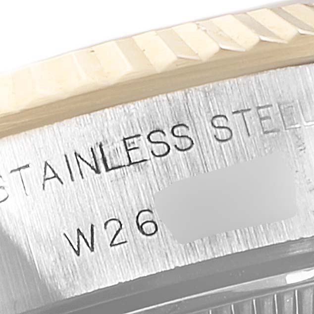 This close-up image of a Rolex Datejust 69173 Women's Steel and Gold (two tone) White Dial 69173 Women's Steel and Gold (two tone) White Dial watch shows part of the fluted bezel and the engraved model details on the case.