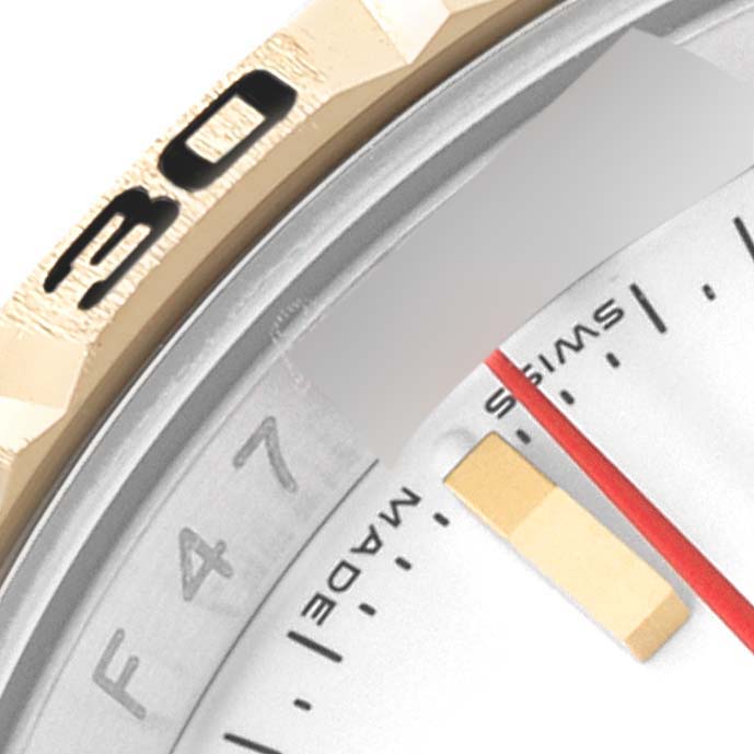 This close-up photo of the Rolex Turn-o-Graph 43821 Men's Steel and Gold (two tone) White Dial 43821 Men's Steel and Gold (two tone) White Dial model shows parts of the bezel and the watch face, including numbers and hands.
