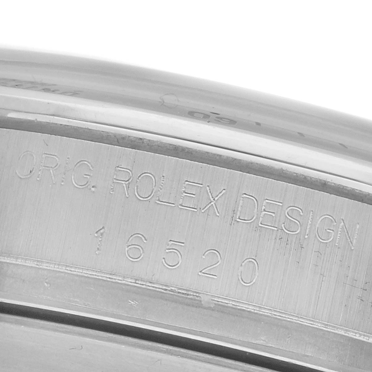 The image shows a close-up of the side of a Rolex Daytona 16520 Men
s Stainless Steel White Dial 16520 Men
s Stainless Steel White Dial watch, highlighting the engraved model number 16520.