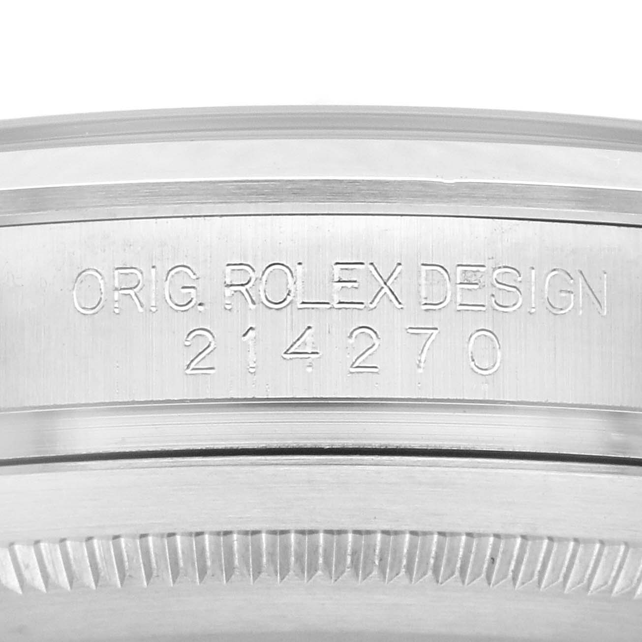 The image shows a close-up of the side of a Rolex Explorer 214270 Men's Stainless Steel Black Dial 214270 Men's Stainless Steel Black Dial case, highlighting the "Orig. Rolex Design 214270" engraving.