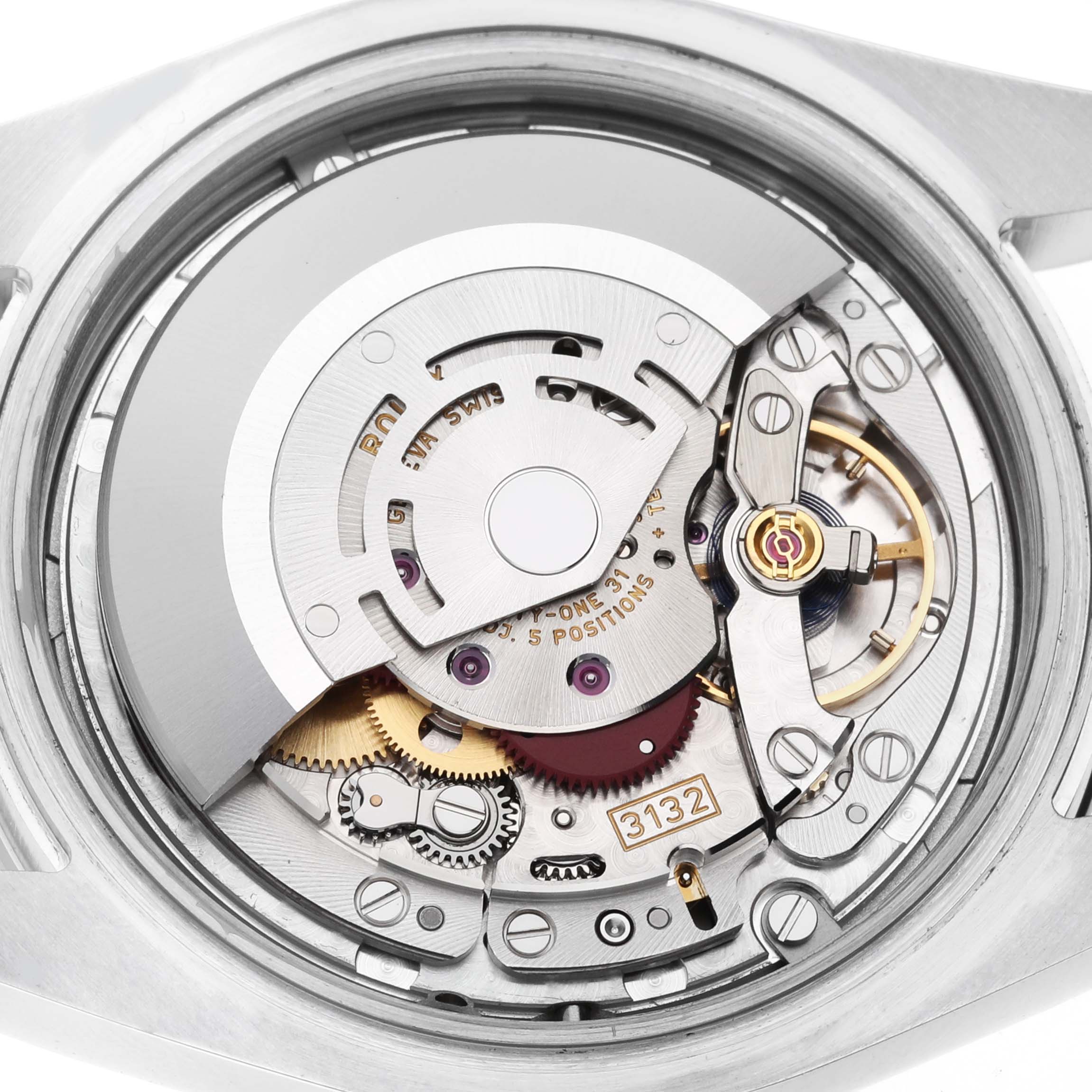 The image shows the movement of a Rolex Explorer 214270 Men's Stainless Steel Black Dial 214270 Men's Stainless Steel Black Dial watch, featuring gears and balance wheel from a top-down angle.