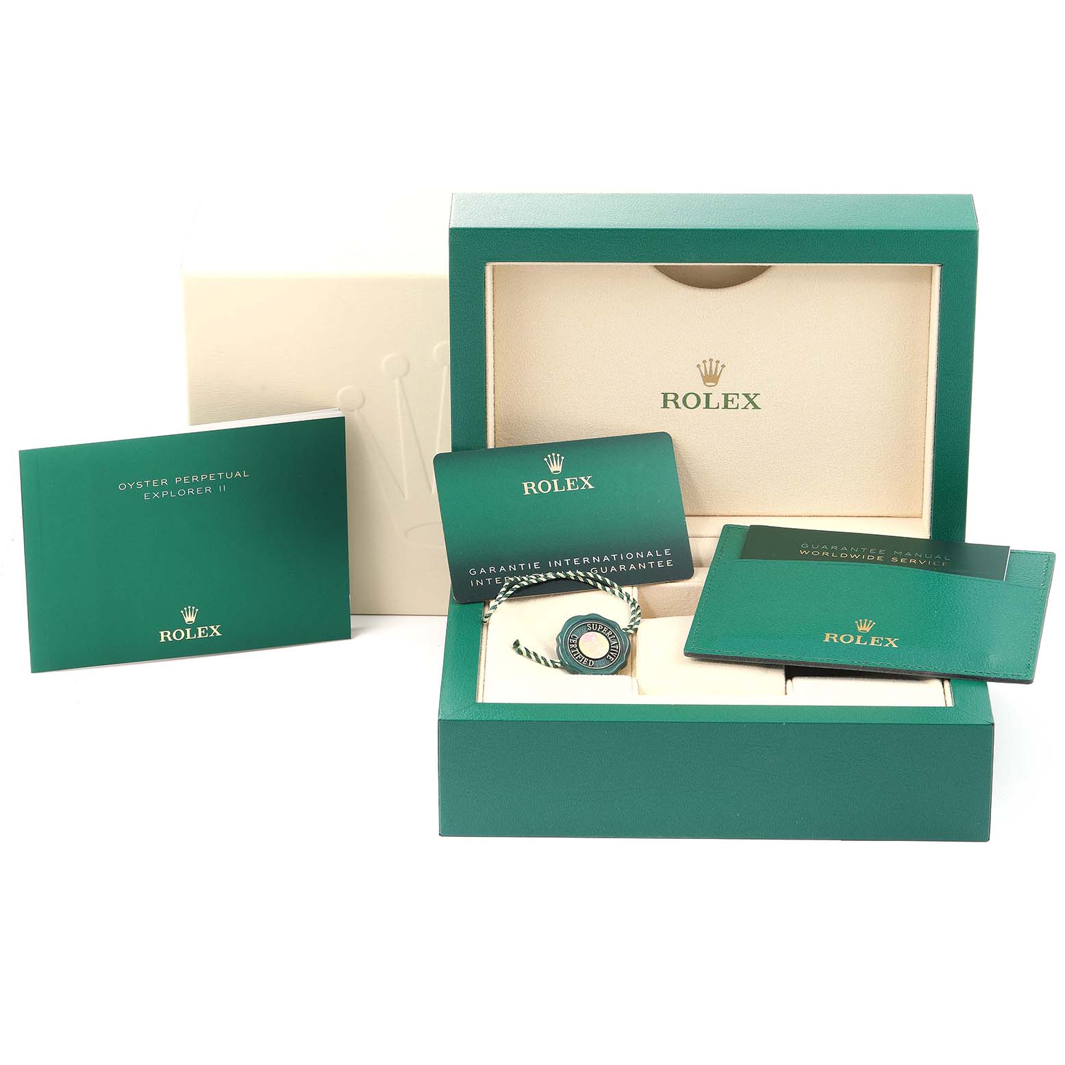 The image shows the packaging and accessories for a Rolex Explorer 216570 Men
s Stainless Steel White Dial 216570 Men
s Stainless Steel White Dial model, including manuals, a guarantee card, and a tag, all in green boxes.