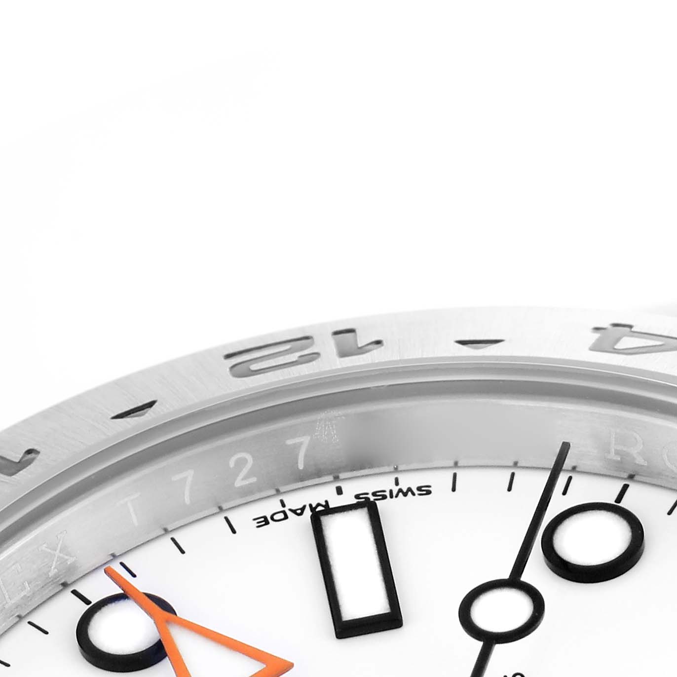 The image shows a close-up of the Rolex Explorer 216570 Men's Stainless Steel White Dial 216570 Men's Stainless Steel White Dial's bezel, dial, and partial hour markers at an angled view.