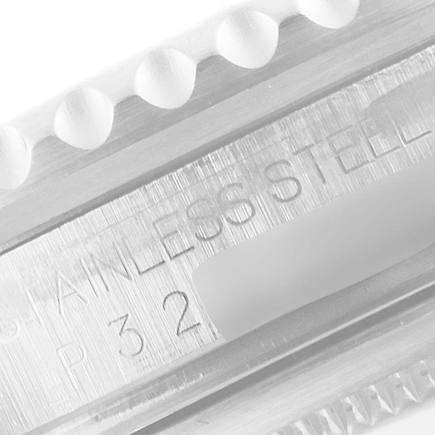 This close-up image of the Rolex GMT-Master 16710 Men
s Stainless Steel Black Dial 16710 Men
s Stainless Steel Black Dial shows the edge of the bezel and part of the band, displaying the "STAINLESS STEEL" inscription.