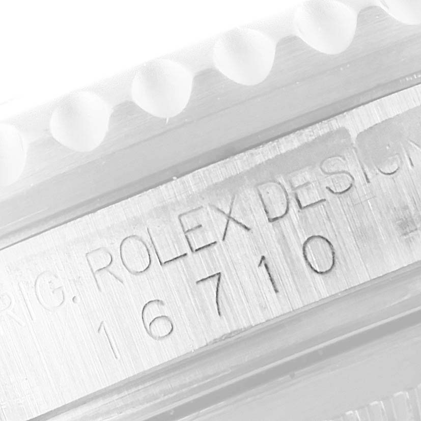 The image shows an angled close-up of the Rolex GMT-Master 16710 Men
s Stainless Steel Black Dial 16710 Men
s Stainless Steel Black Dial model 16710, highlighting the engraved model number.