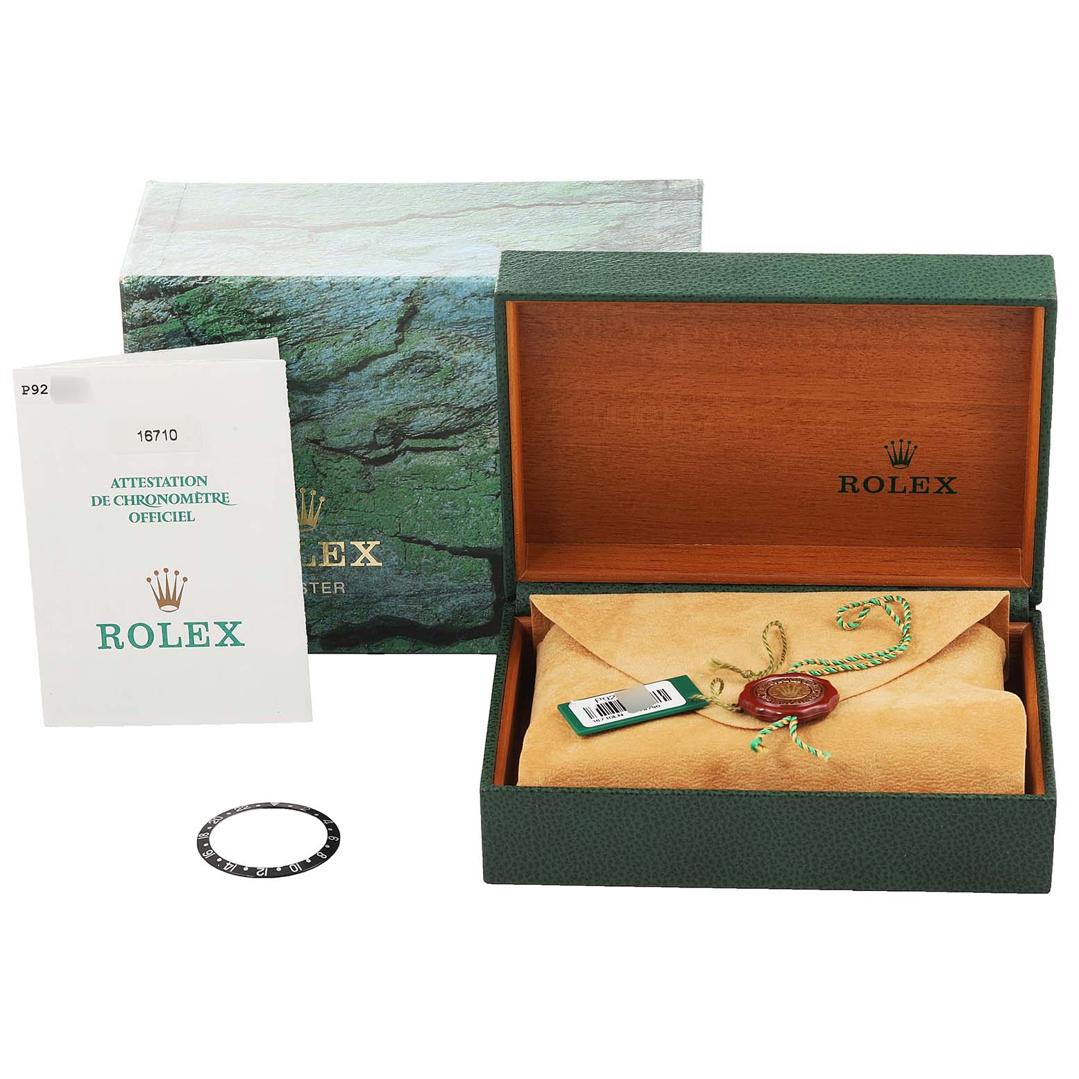 The image shows a Rolex GMT-Master 16710 Men's Stainless Steel Black Dial 16710 Men's Stainless Steel Black Dial watch box, warranty pamphlet, and an additional bezel ring from a top-down angle.