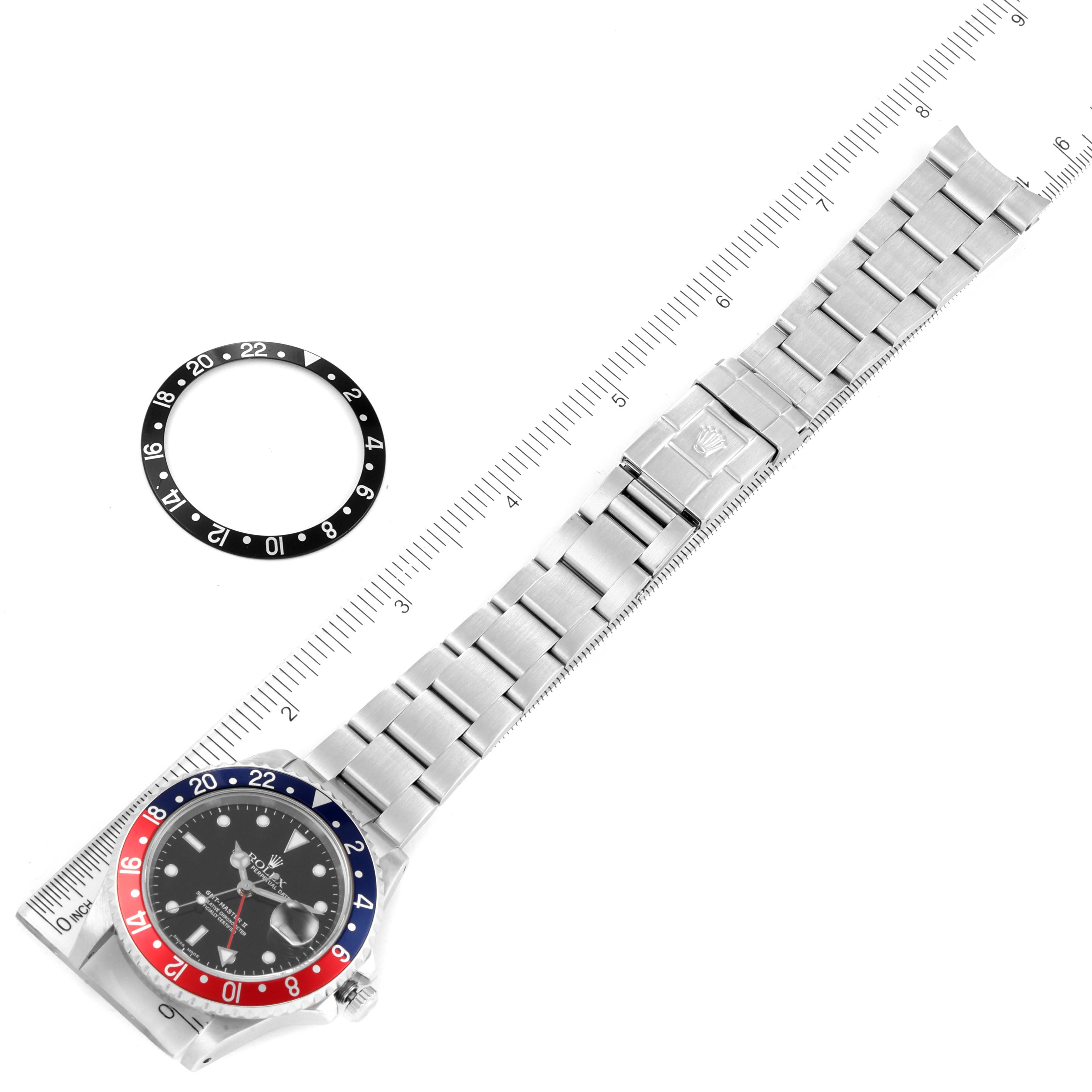 The image shows a top view of a Rolex GMT-Master 16710 Men's Stainless Steel Black Dial 16710 Men's Stainless Steel Black Dial watch and a black bezel ring placed beside it.