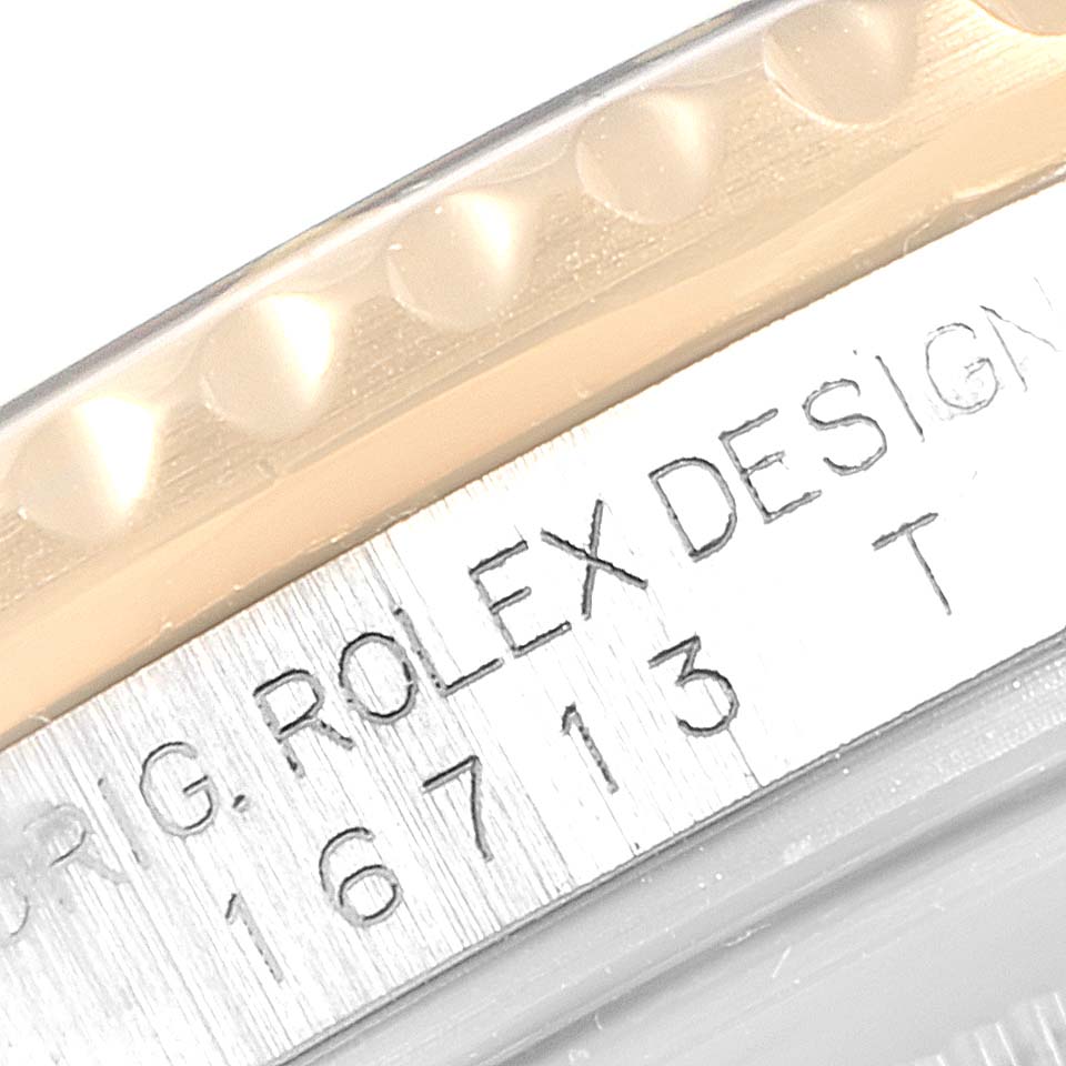 The image shows a close-up angle of the model number and logo engraving on the side of a Rolex GMT-Master 16713 Men's Steel and Gold (two tone) Black Dial 16713 Men's Steel and Gold (two tone) Black Dial watch.