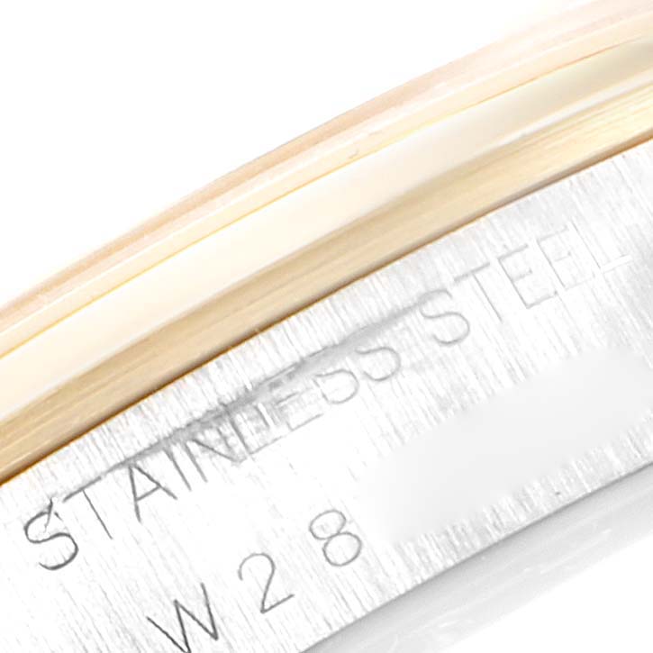 This close-up image shows the stainless steel case side of a Rolex Oyster Perpetual 14203 Men's Steel and Gold (two tone) Grey Dial 14203 Men's Steel and Gold (two tone) Grey Dial watch with engraved text.