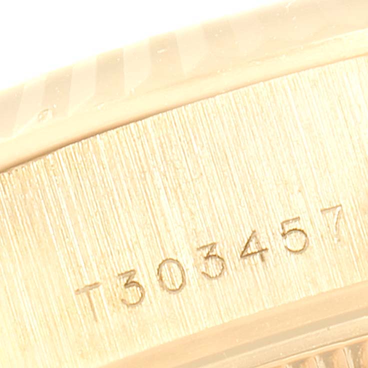 This close-up image shows the serial number engraved on the side of a Rolex President 69178 Women's Yellow Gold Black Dial 69178 Women's Yellow Gold Black Dial model watch.