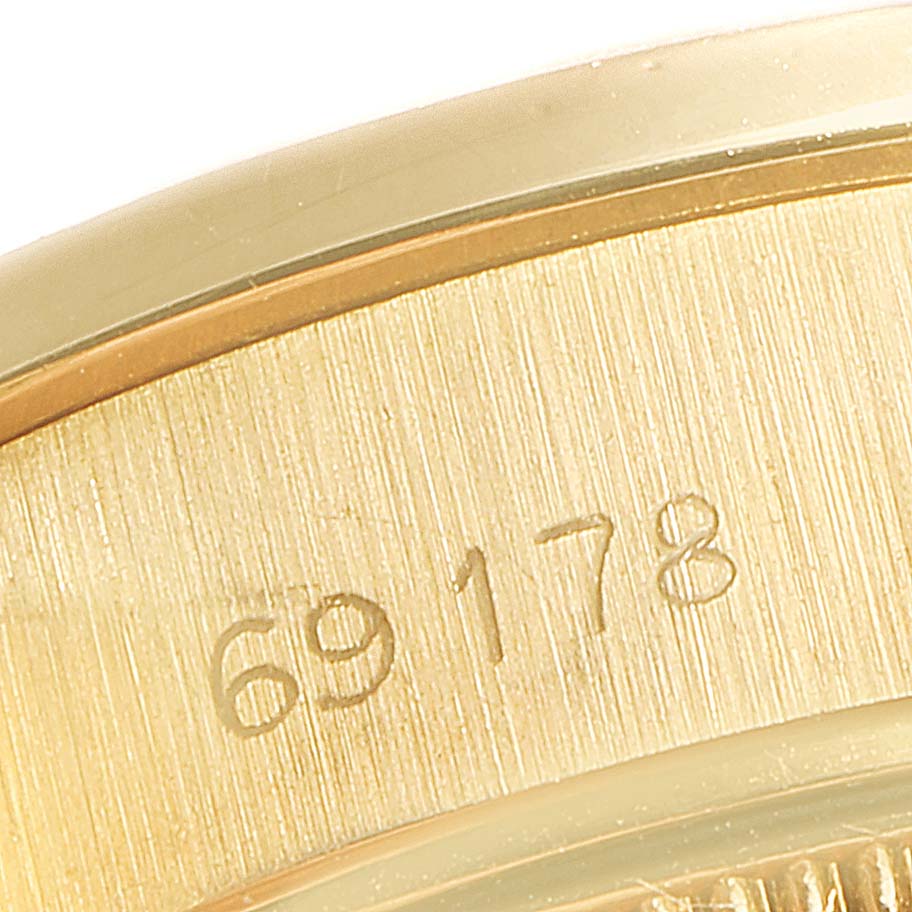 The image is a close-up of the serial number on the case of a Rolex President 69178 Women
s Yellow Gold Champagne Dial 69178 Women
s Yellow Gold Champagne Dial model watch.
