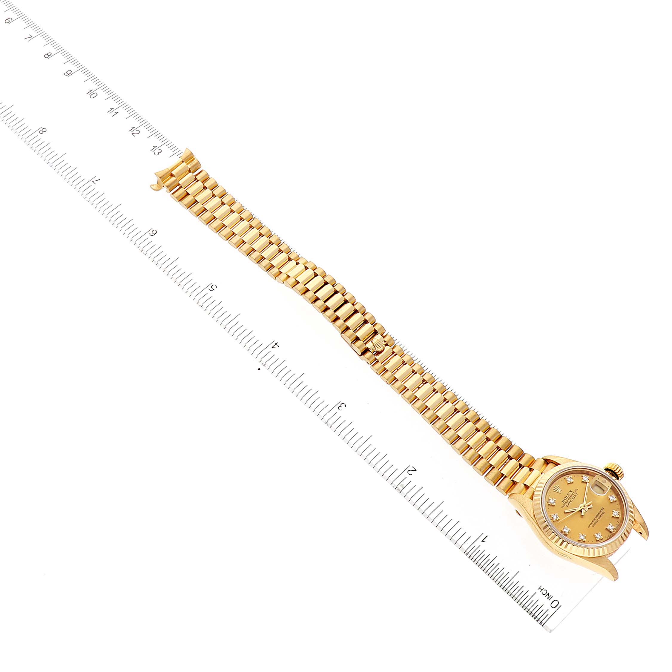 The image shows a gold Rolex President 69178 Women
s Yellow Gold Champagne Dial 69178 Women
s Yellow Gold Champagne Dial model watch laid flat, with the dial on the right and an open band measured by a ruler.