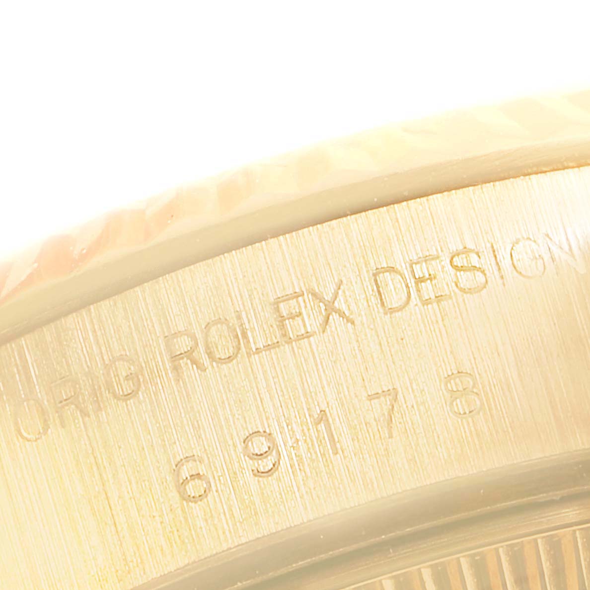This close-up image shows the engraved side of a Rolex President 69178 Women
s Yellow Gold Champagne Dial 69178 Women
s Yellow Gold Champagne Dial model watch.