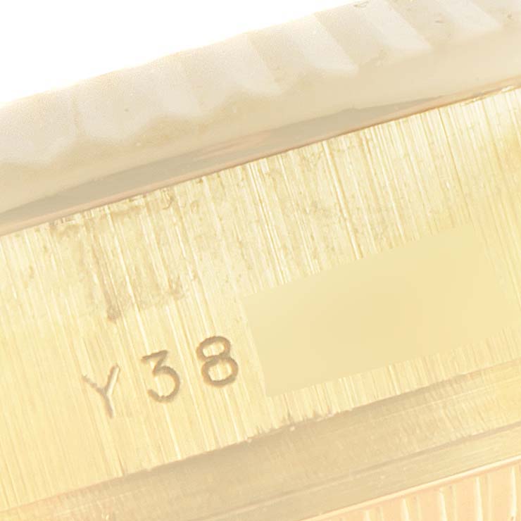 This close-up image shows the side of a Rolex President 179178 Women
s Yellow Gold Champagne Dial 179178 Women
s Yellow Gold Champagne Dial model watch, specifically the serial number engraving.