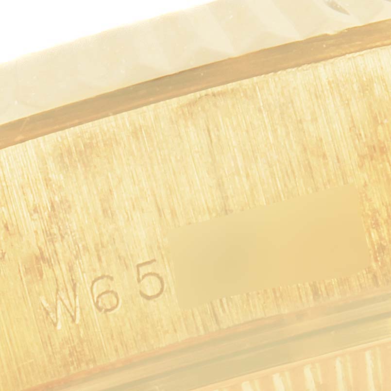 The image shows a close-up view of Rolex President 69178 Women's Yellow Gold Champagne Dial 69178 Women's Yellow Gold Champagne Dial model watch, focusing on the serial number and bezel's side.