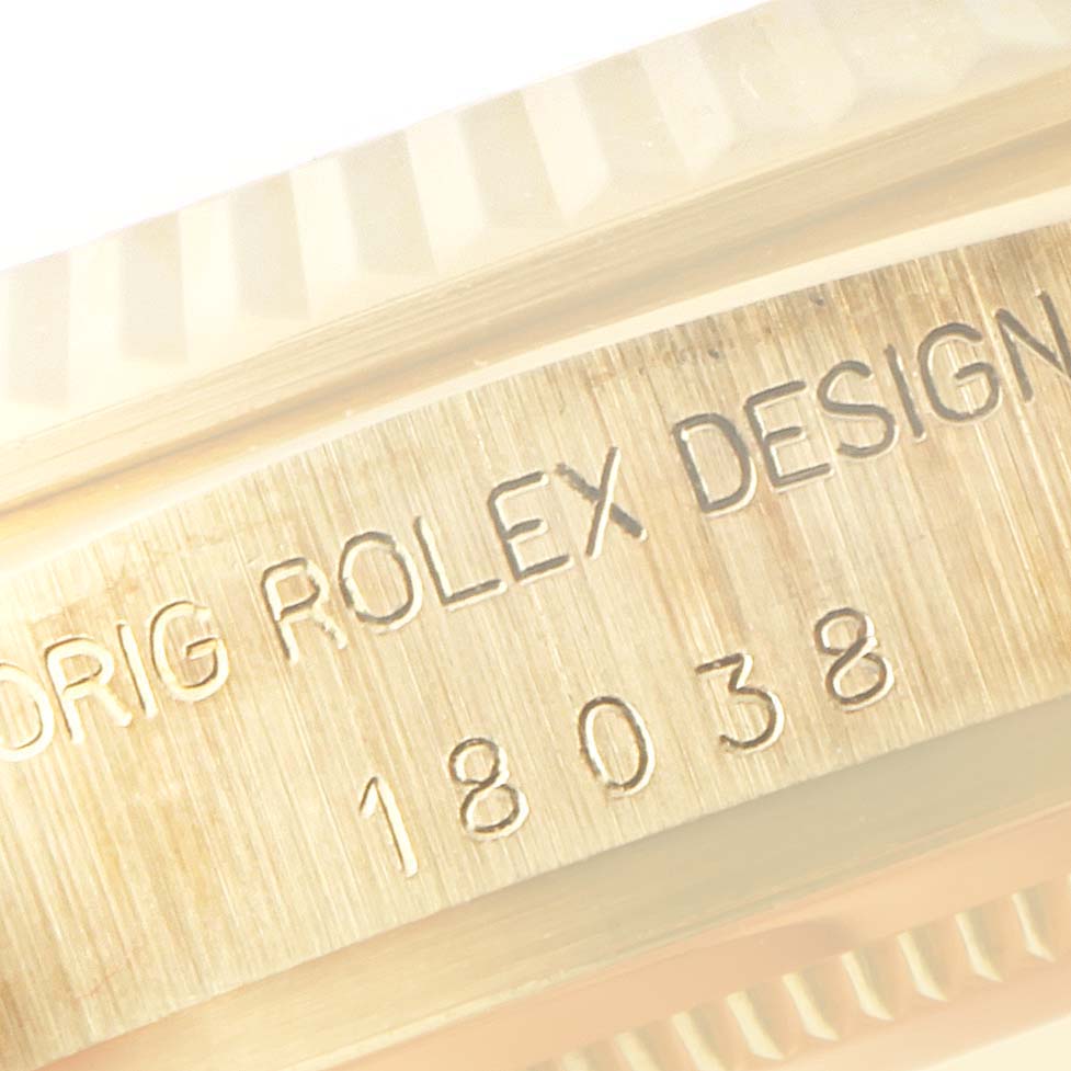 The image shows a close-up of the side view of a Rolex President 18038 Men
s Yellow Gold Champagne Dial 18038 Men
s Yellow Gold Champagne Dial model watch, highlighting its engraving details.