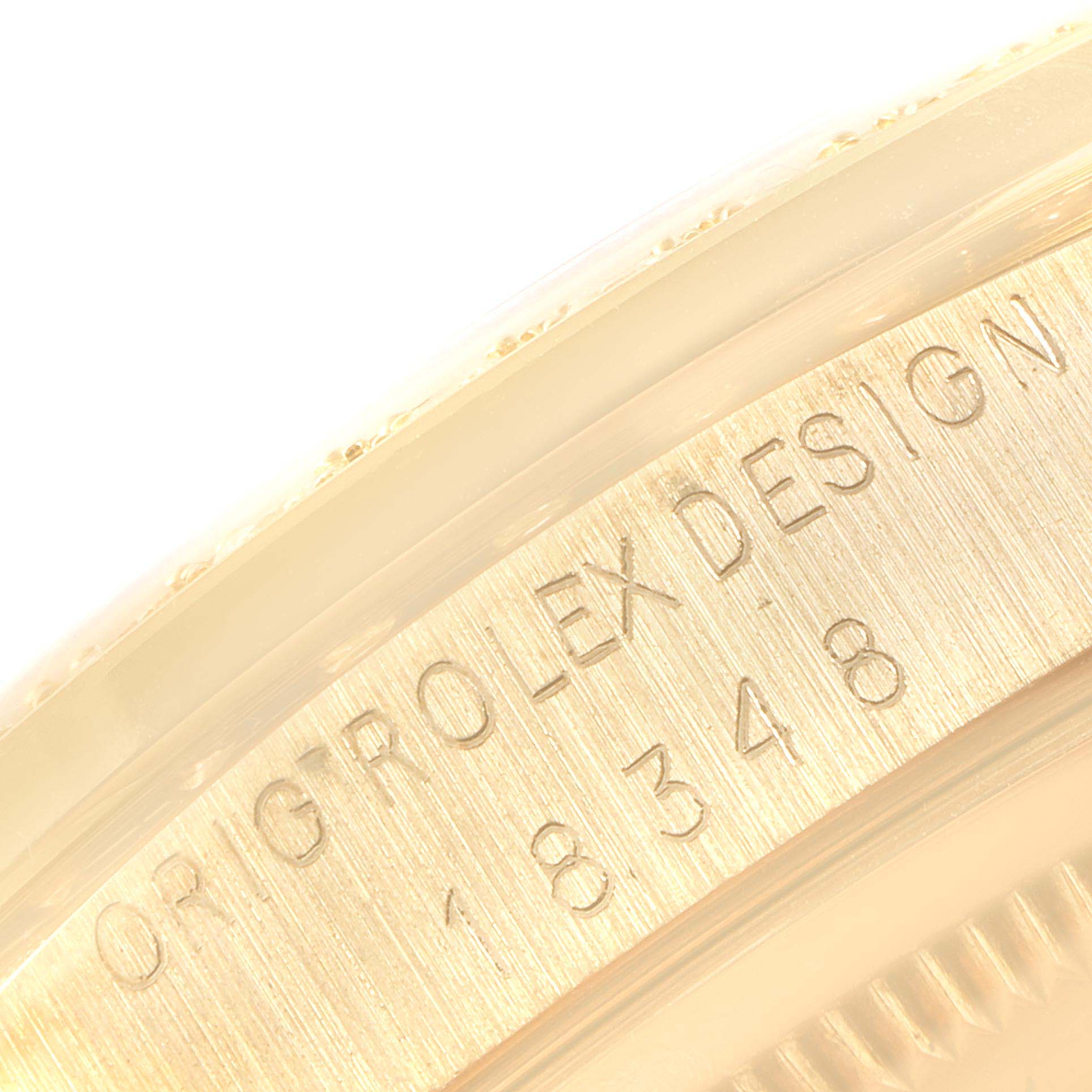 The image shows a close-up of the serial number and design engraving on the case side of the Rolex President 18348 Men's Yellow Gold Champagne Dial 18348 Men's Yellow Gold Champagne Dial model watch.