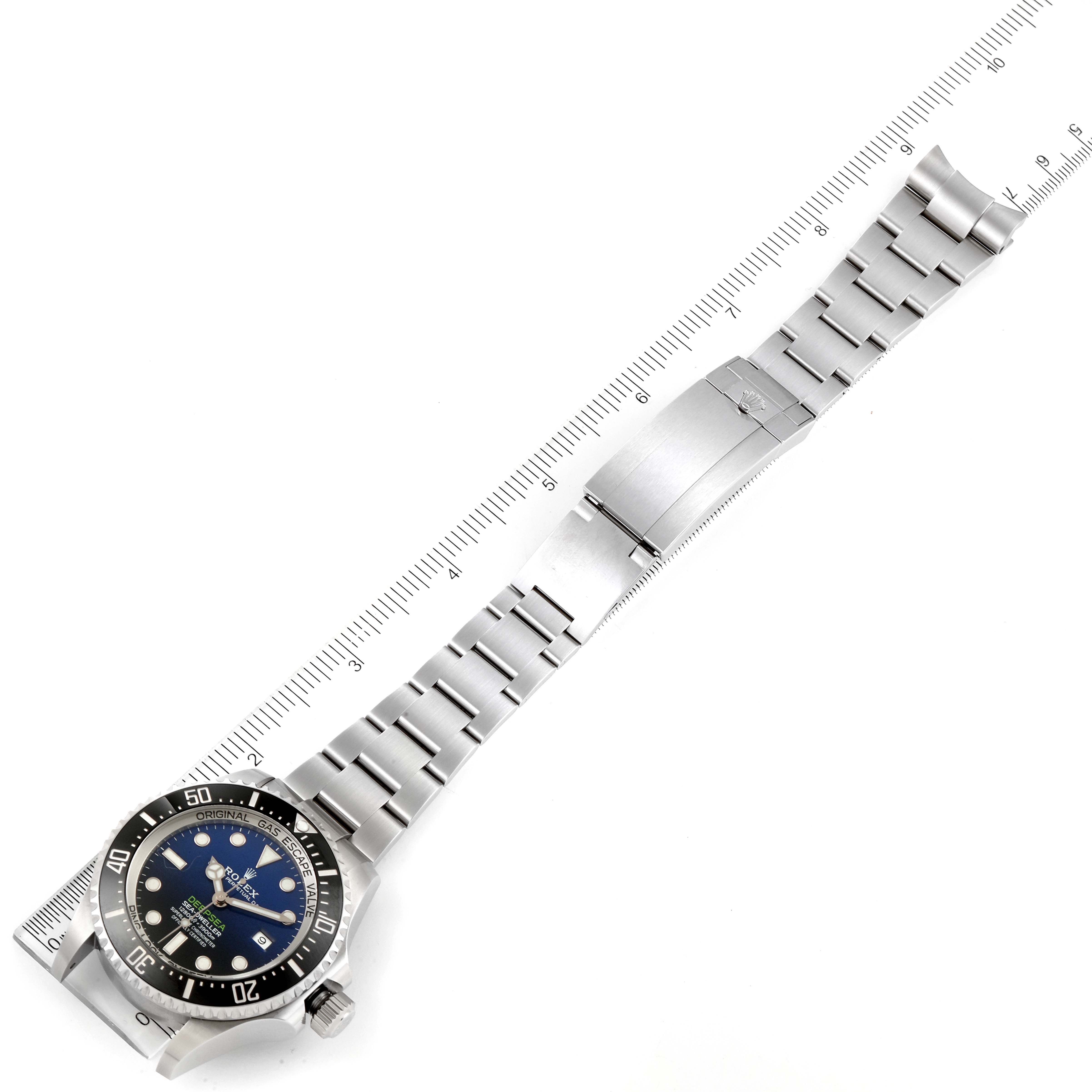The Rolex Sea-Dweller 126660 Men's Stainless Steel Blue Dial 126660 Men's Stainless Steel Blue Dial watch is shown from an overhead angle, with the full bracelet and clasp visible alongside a ruler for scale.