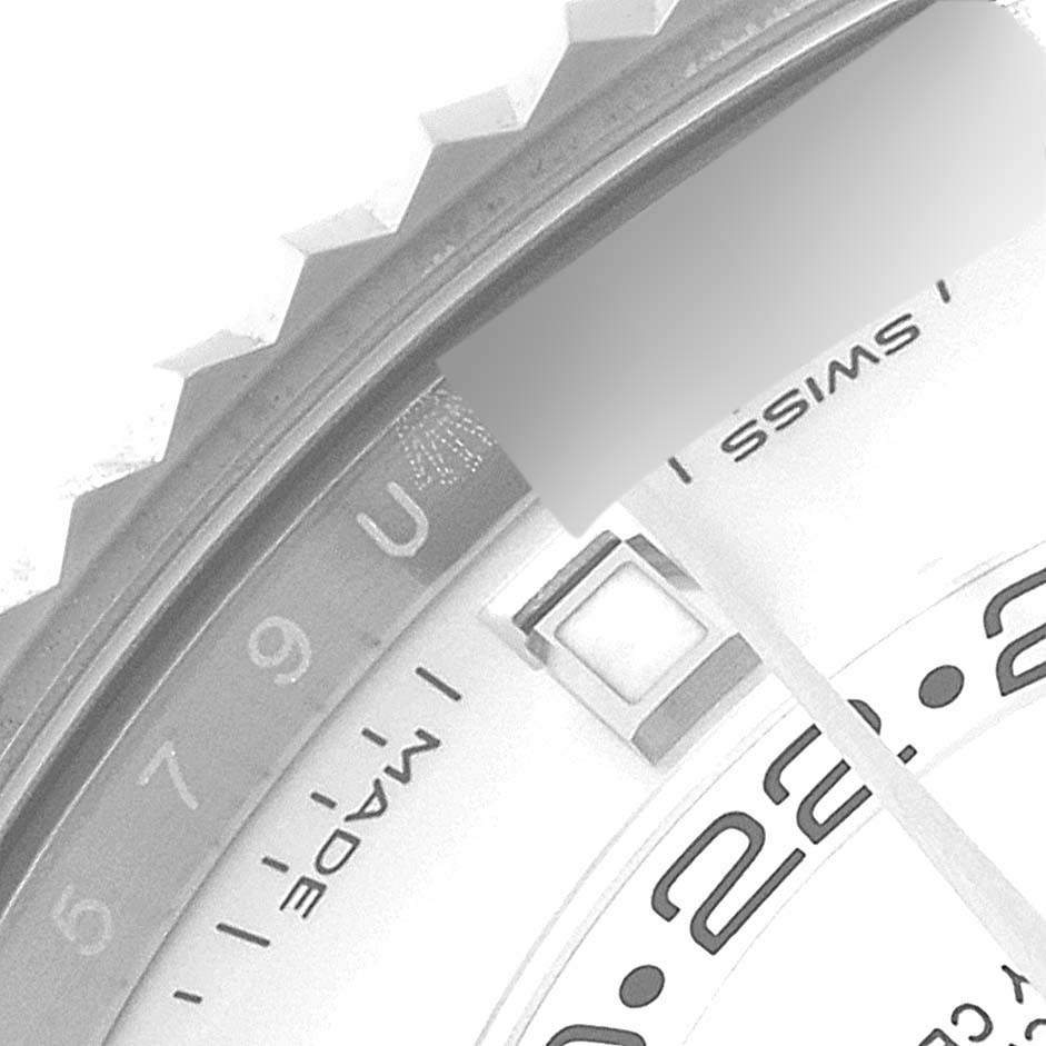 This close-up image of the Rolex Sky-Dweller 326934 Men's Stainless Steel White Dial 326934 Men's Stainless Steel White Dial watch shows part of the bezel, dial, and "Swiss Made" text.