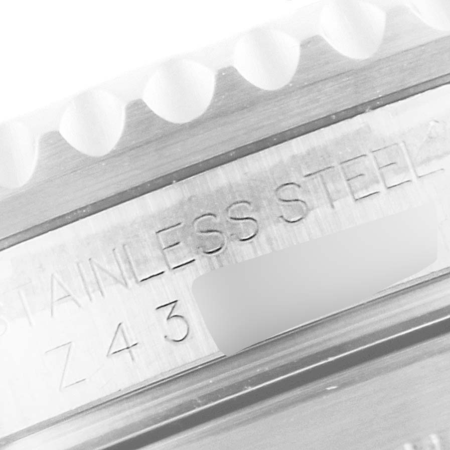 The image shows a close-up of the stainless steel case of a Rolex Submariner 16610 Men
s Stainless Steel Black Dial 16610 Men
s Stainless Steel Black Dial watch with engraved markings.