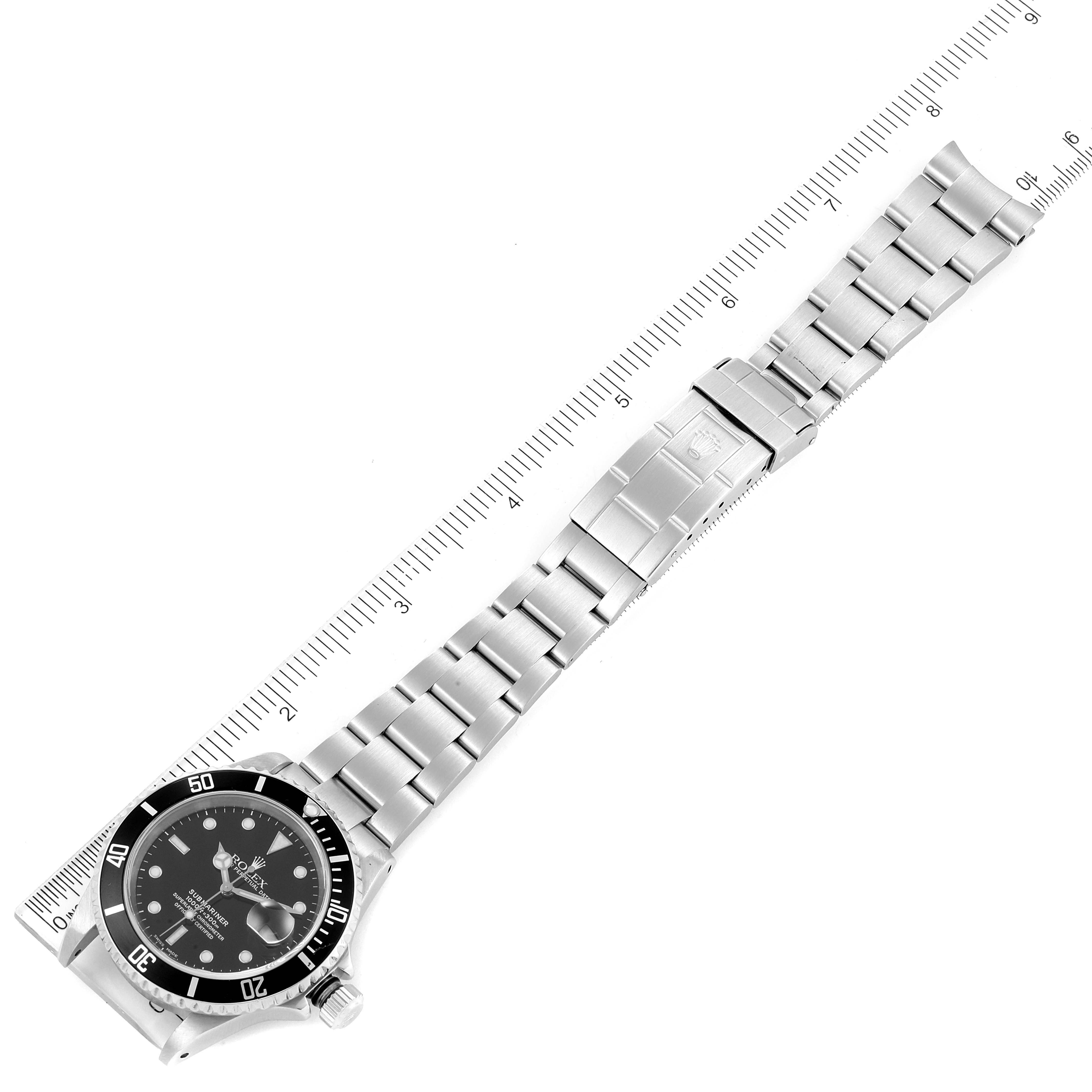 The image shows the full length of the Rolex Submariner 16610 Men
s Stainless Steel Black Dial 16610 Men
s Stainless Steel Black Dial watch laid flat with its stainless steel bracelet and clasp.