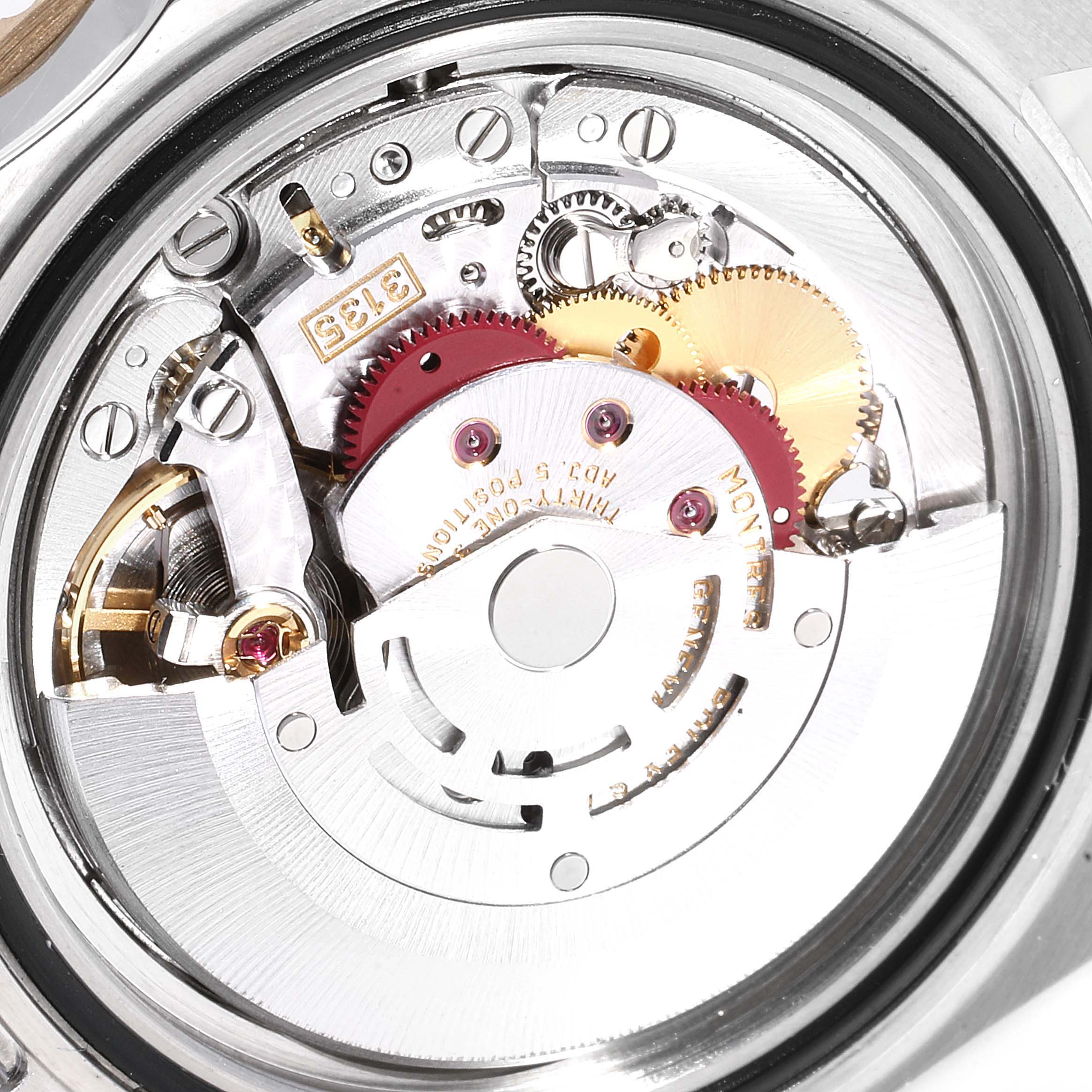 The image shows a detailed view of the internal mechanism of the Rolex Submariner 16613 Men
s Steel and Gold (two tone) Blue Dial 16613 Men
s Steel and Gold (two tone) Blue Dial watch, highlighting gears and movement components.