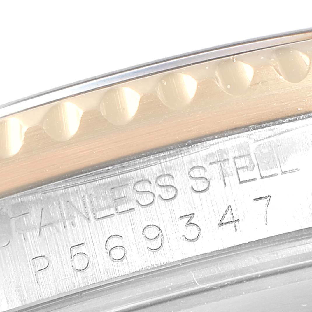 This close-up image shows the serial number and part of the bezel of a Rolex Submariner 16613 Men
s Steel and Gold (two tone) Blue Dial 16613 Men
s Steel and Gold (two tone) Blue Dial watch.