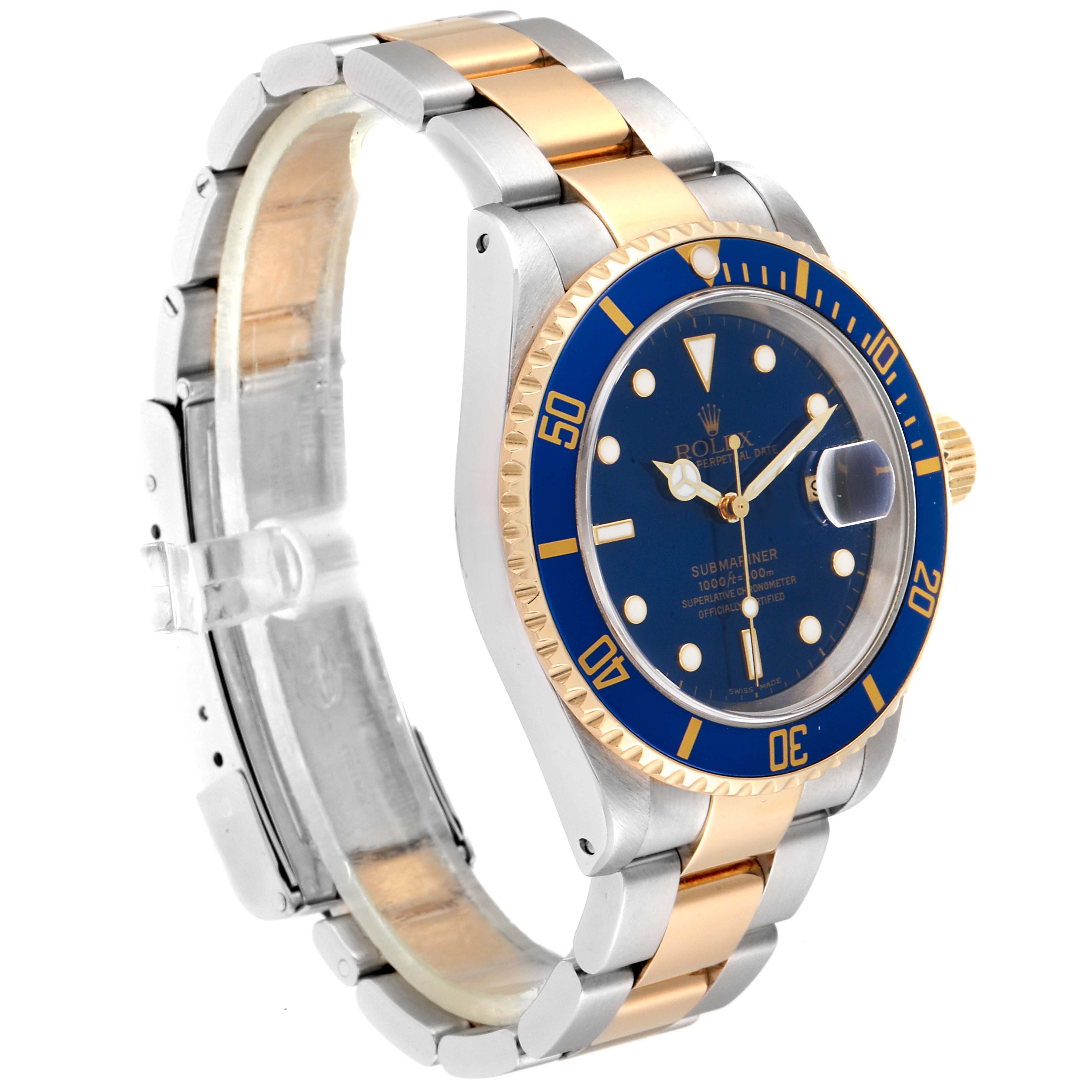 The image shows a Rolex Submariner 16613 Men
s Steel and Gold (two tone) Blue Dial 16613 Men
s Steel and Gold (two tone) Blue Dial watch with a blue dial, two-tone bracelet, and gold accents, angled from the front-left.