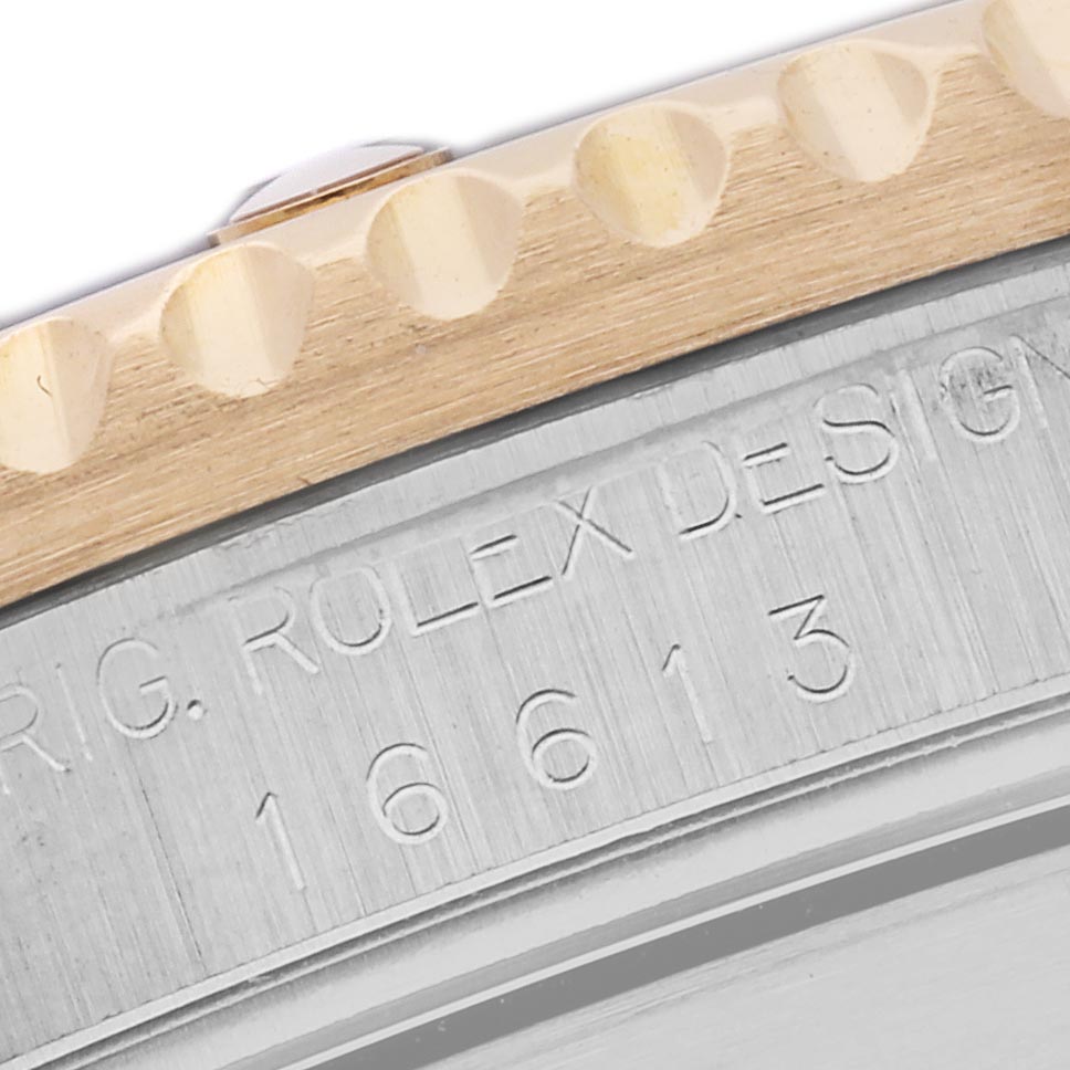 The image shows a close-up of the bezel and engraved serial number on the side of a Rolex Submariner 16613 Men
s Steel and Gold (two tone) Silver Dial 16613 Men
s Steel and Gold (two tone) Silver Dial watch.