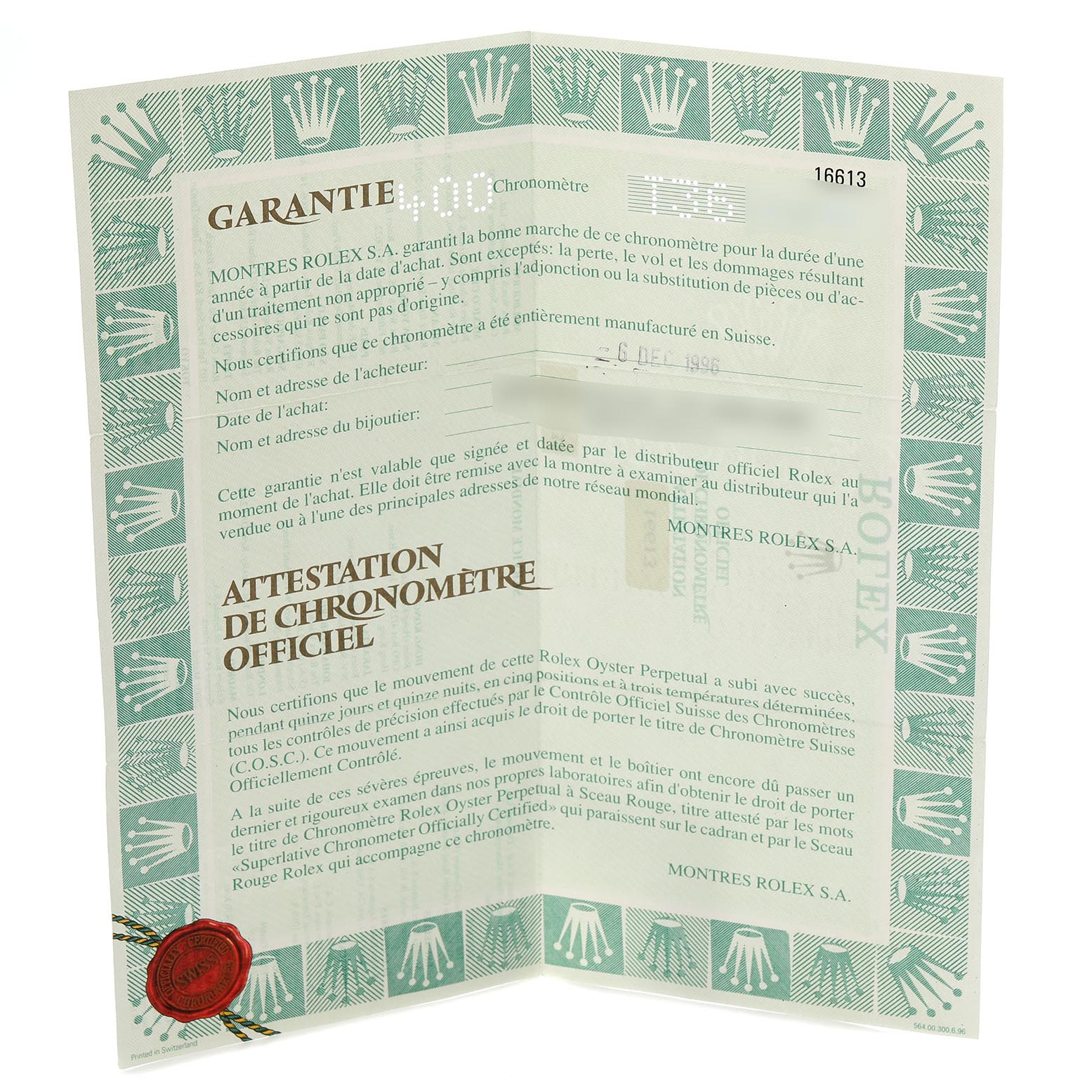 The image shows a folded warranty certificate for the Rolex Submariner 16613 Men
s Steel and Gold (two tone) Silver Dial 16613 Men
s Steel and Gold (two tone) Silver Dial, featuring text and a red seal.