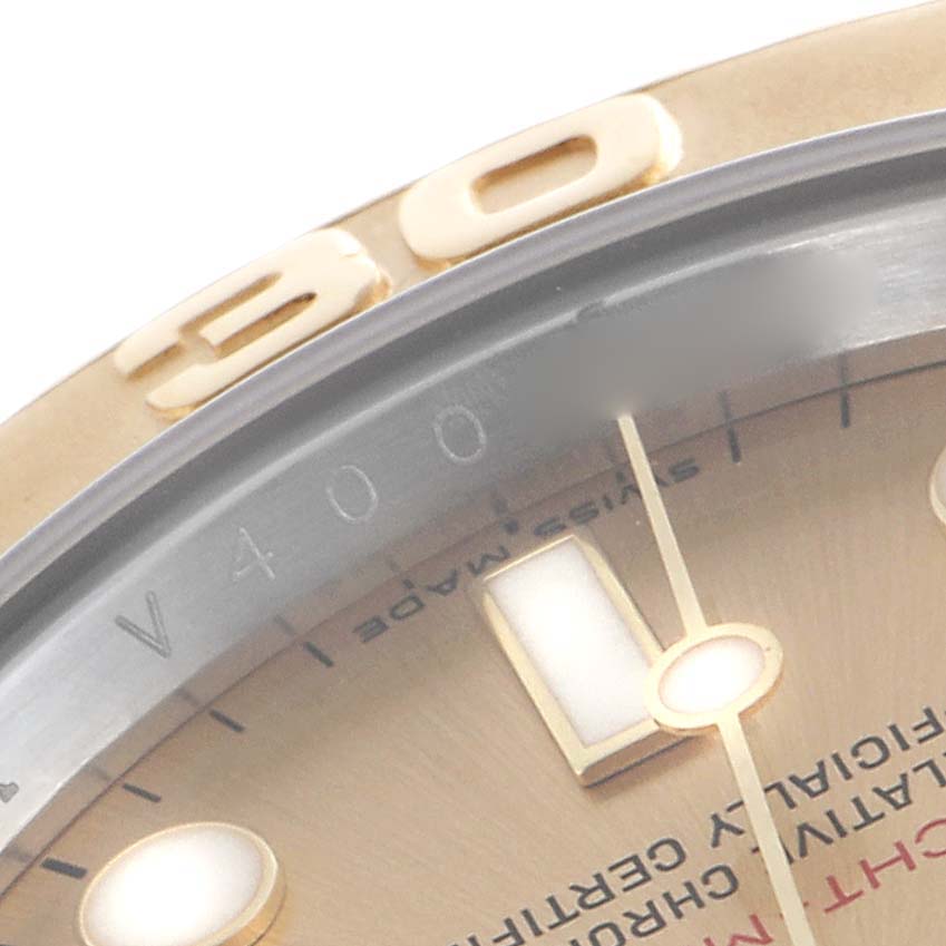 The image shows a close-up of the bezel and part of the dial on a Rolex Yacht-Master 16623 Men's Steel and Gold (two tone) Champagne Dial 16623 Men's Steel and Gold (two tone) Champagne Dial watch.
