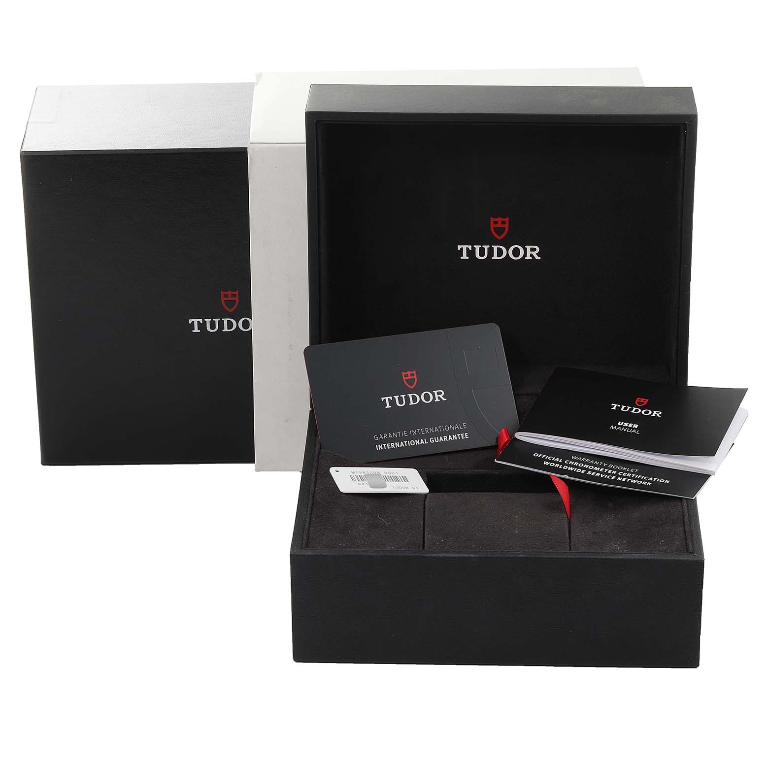 The Heritage Black Bay Tudor watch box and accompanying accessories, including the international guarantee card and user manual, are shown from the front.