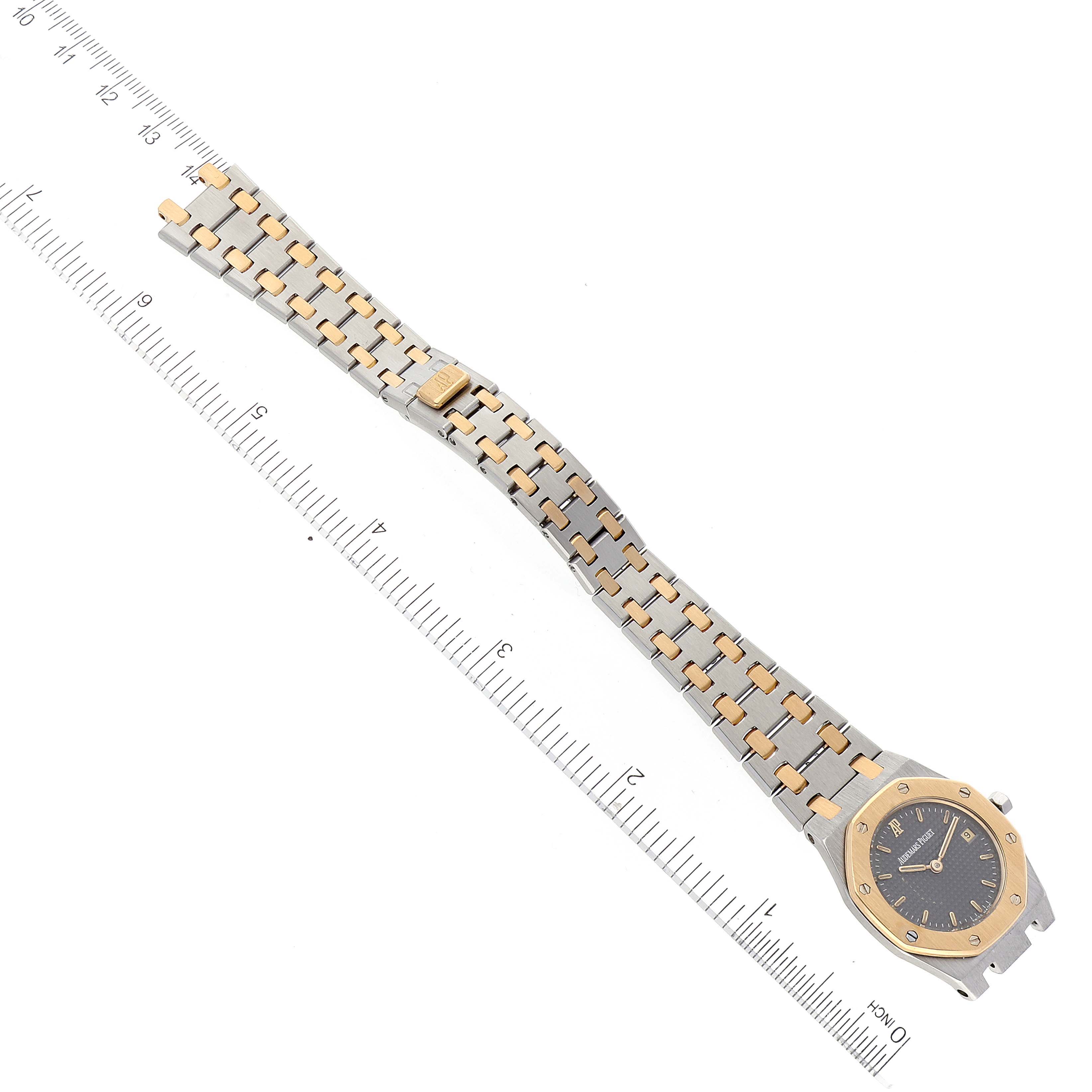 The image shows an Audemars Piguet Royal Oak Women's Steel and Gold (two tone) Grey Dial Women's Steel and Gold (two tone) Grey Dial watch laid flat with the bracelet and watch face visible, along with a measurement scale.