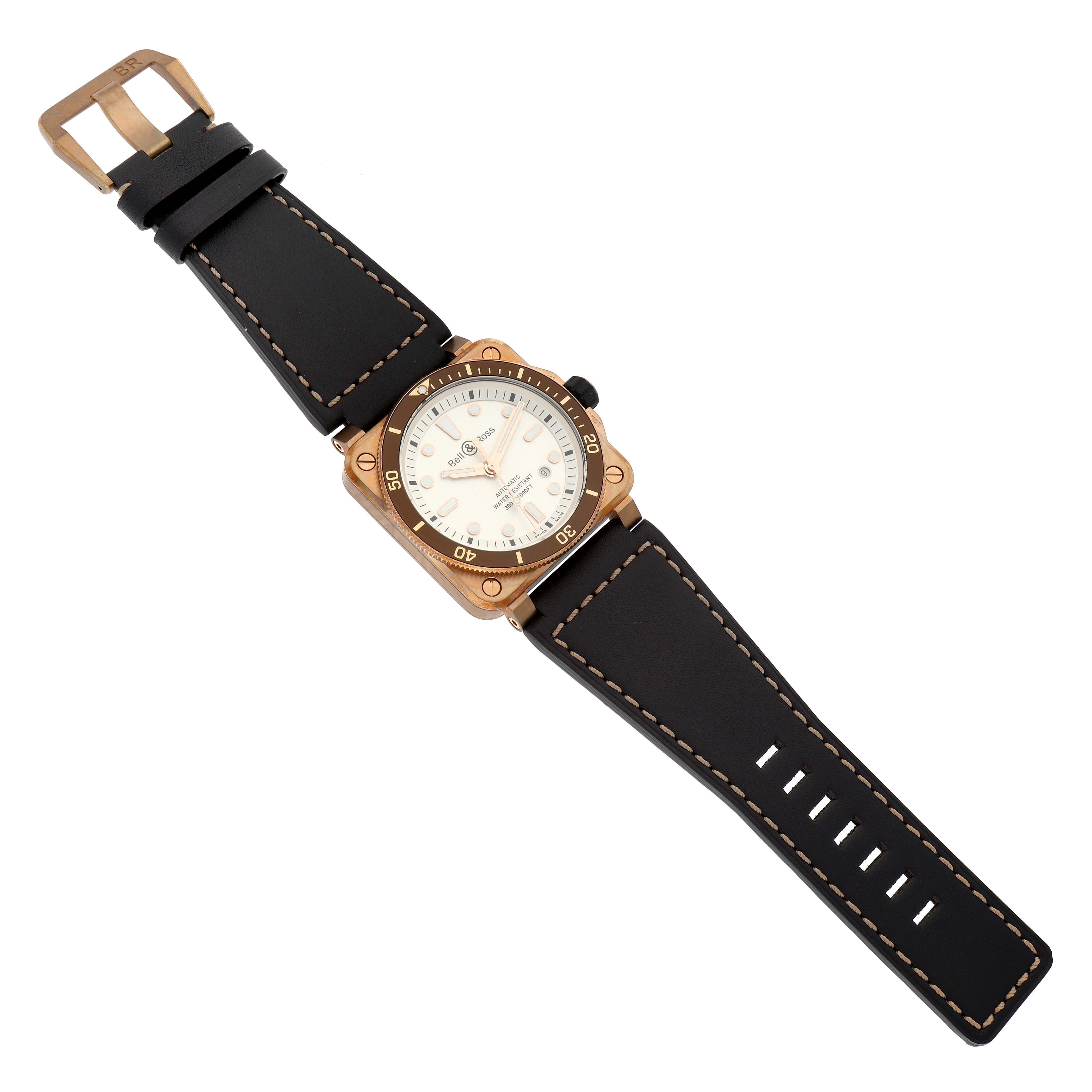 The image shows a Bell 
Ross Instruments BR0392-D-WH-BR/SCA Men
s Bronze Silver Dial BR0392-D-WH-BR/SCA Men
s Bronze Silver Dial model watch from a top-down angle, displaying its black strap, bronze case, and white dial.
