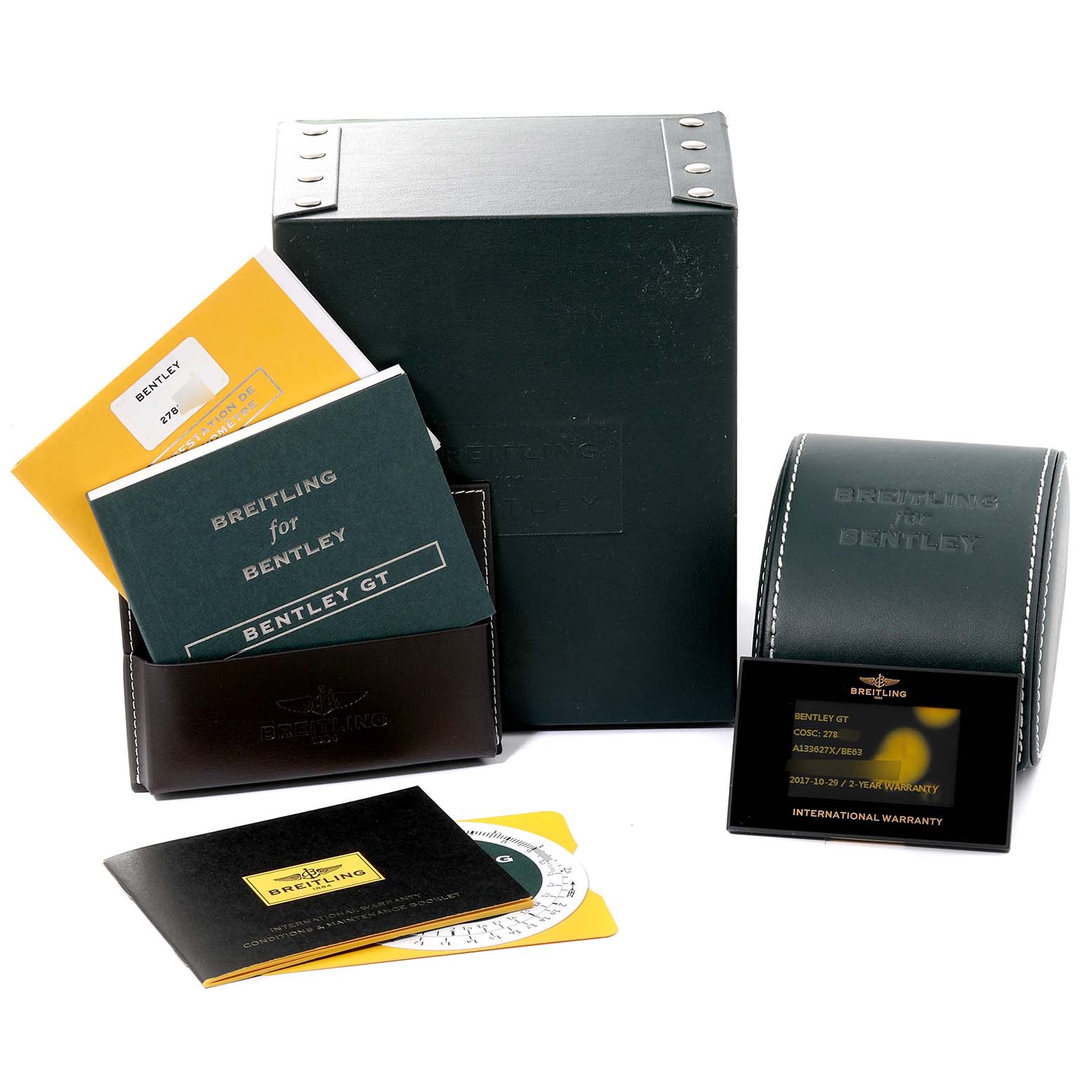 The image shows the packaging and accessories of the Bentley model by Breitling, including the box, manuals, and warranty card.