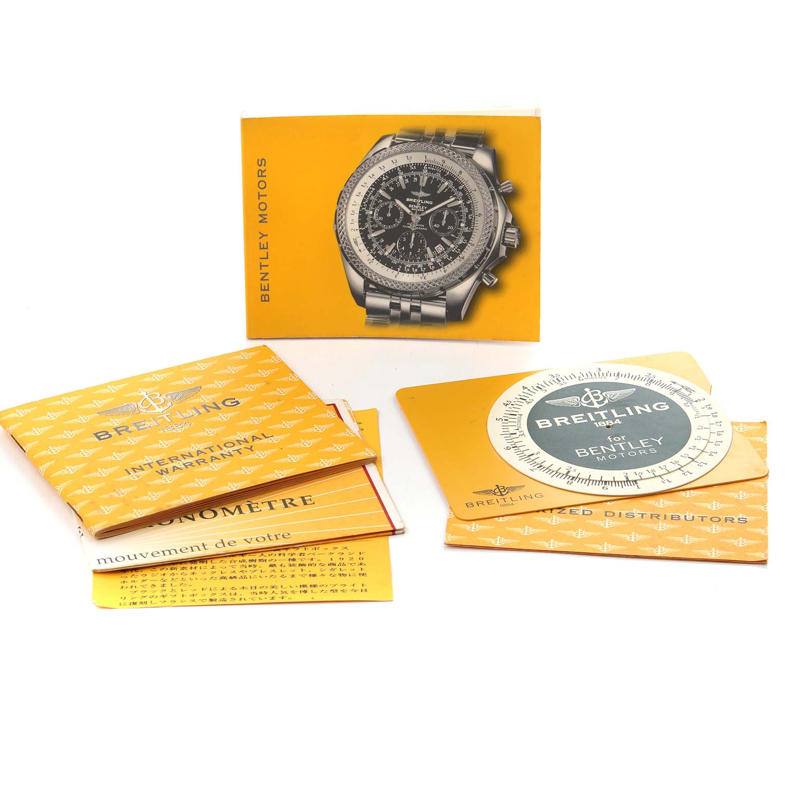 The image shows a Breitling Bentley K25362 Men's Yellow Gold White Dial K25362 Men's Yellow Gold White Dial watch booklet and accessories, including manuals and warranty cards.