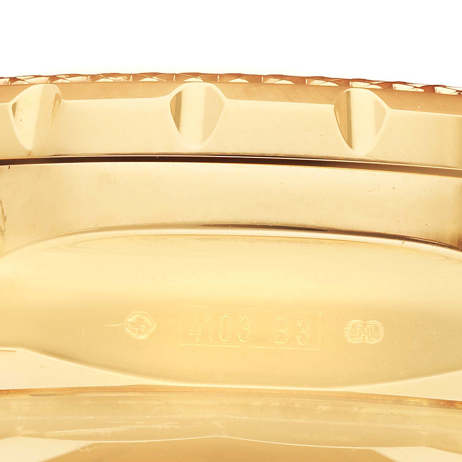 The Breitling Bentley K25362 Men's Yellow Gold White Dial K25362 Men's Yellow Gold White Dial watch is shown from a side profile, highlighting the bezel and part of the case with engraved serial numbers.