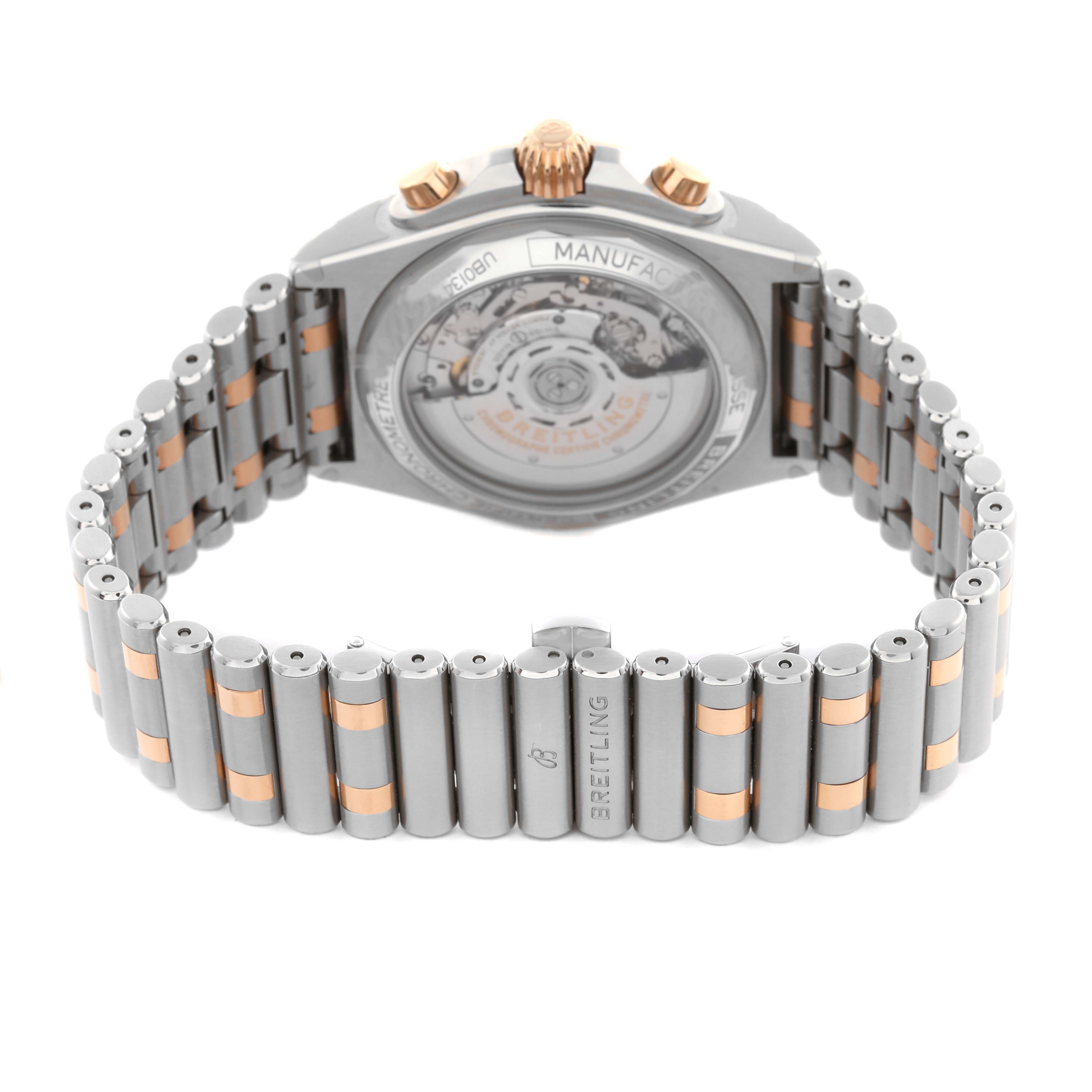 The image shows the back view of a Breitling Chronomat UB0134101C1U1 Men's Steel and Gold (two tone) Blue Dial UB0134101C1U1 Men's Steel and Gold (two tone) Blue Dial watch, highlighting the exhibition case back and metal bracelet.