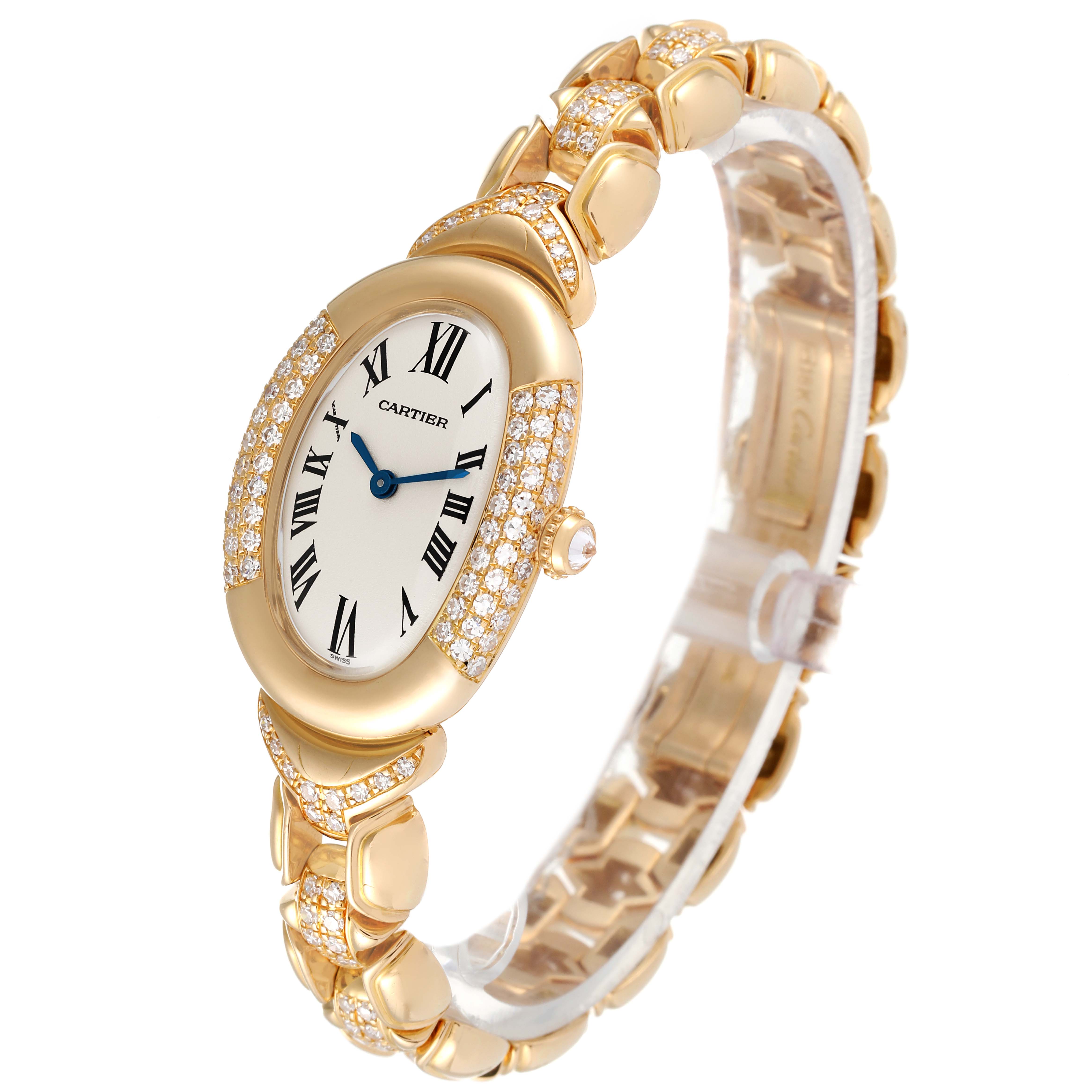 The image shows a Cartier Baignoire 1812 Women's Yellow Gold Silver Dial 1812 Women's Yellow Gold Silver Dial model watch at a three-quarter angle, highlighting its oval face, diamond-encrusted bezel, and gold bracelet.