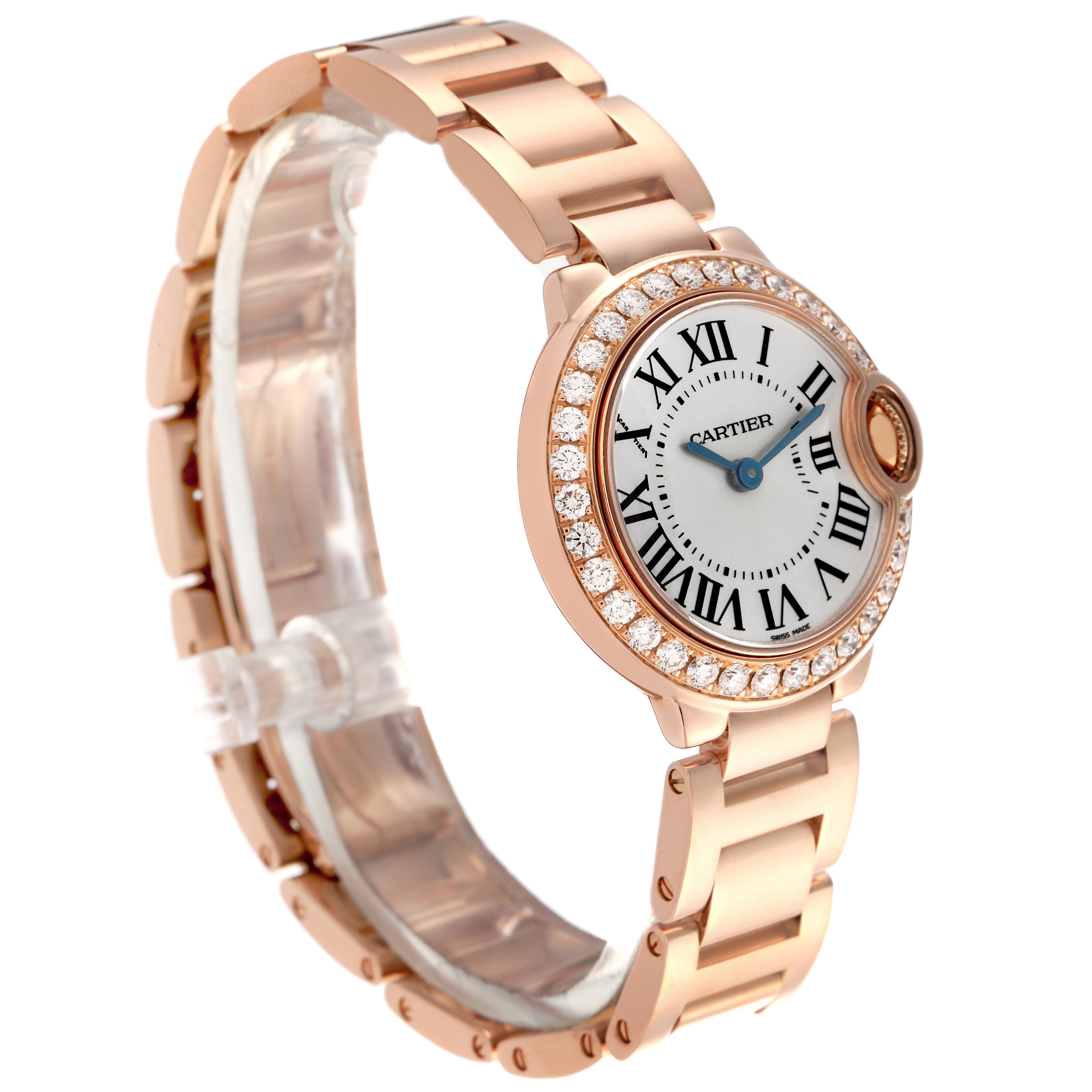 The Ballon Bleu by Cartier is shown from a three-quarter angle, highlighting the dial, diamond bezel, and bracelet.