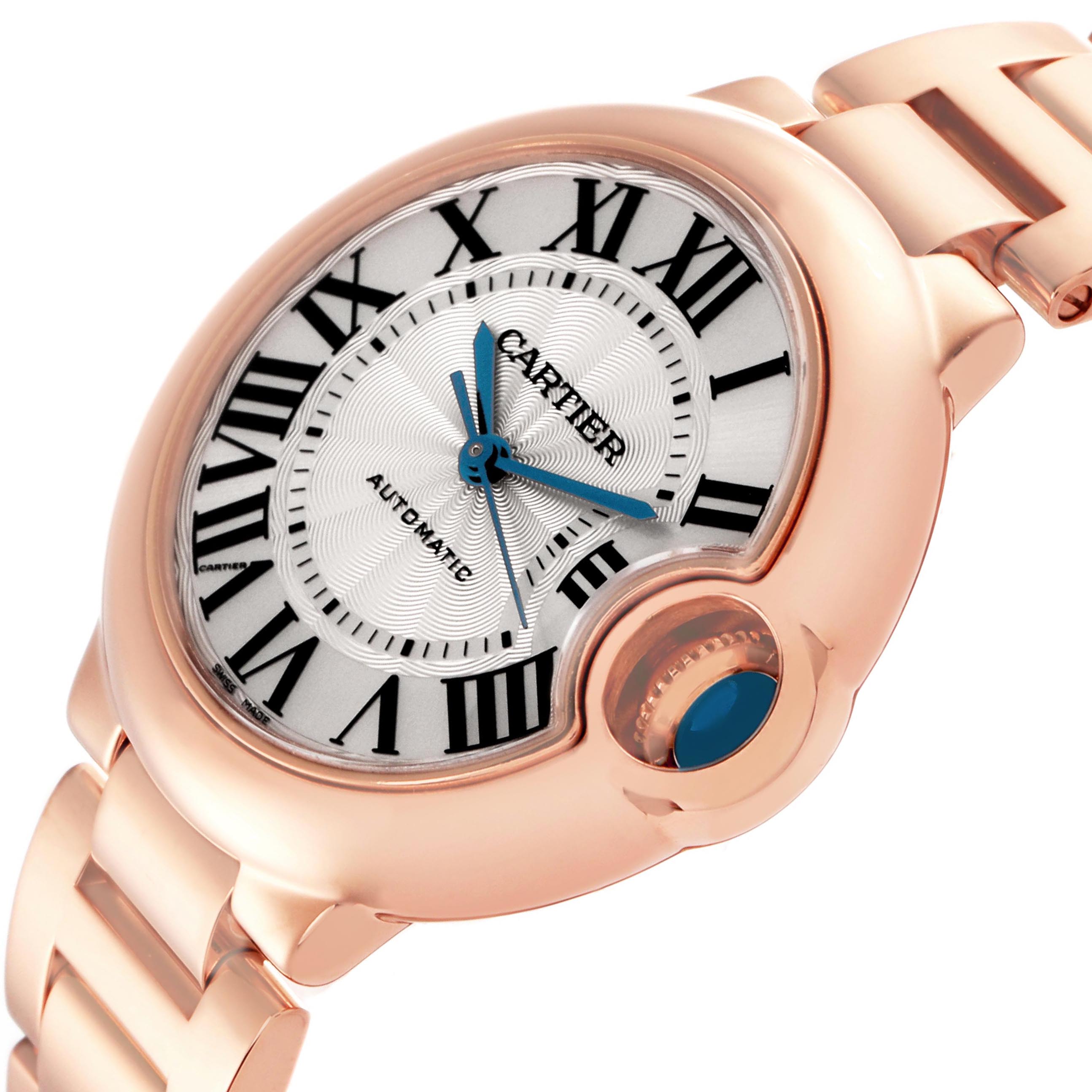 The Cartier Ballon Bleu W6920096 Women's Rose Gold Red Dial W6920096 Women's Rose Gold Red Dial watch is shown at an angled close-up, highlighting the dial, Roman numerals, and crown.