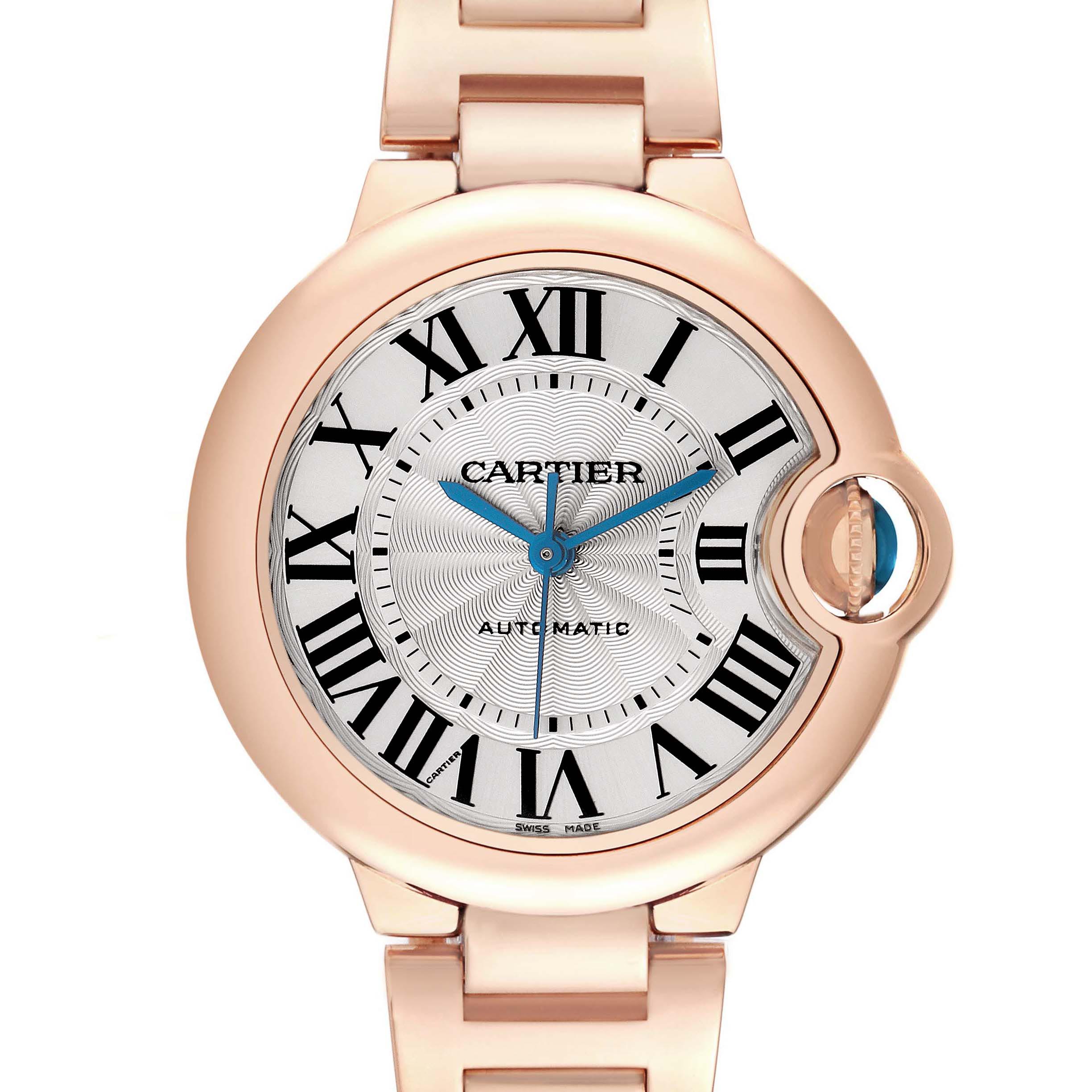 The Cartier Ballon Bleu W6920096 Women's Rose Gold Red Dial W6920096 Women's Rose Gold Red Dial watch is shown from the front, highlighting its round face, Roman numerals, blue hands, and crown.