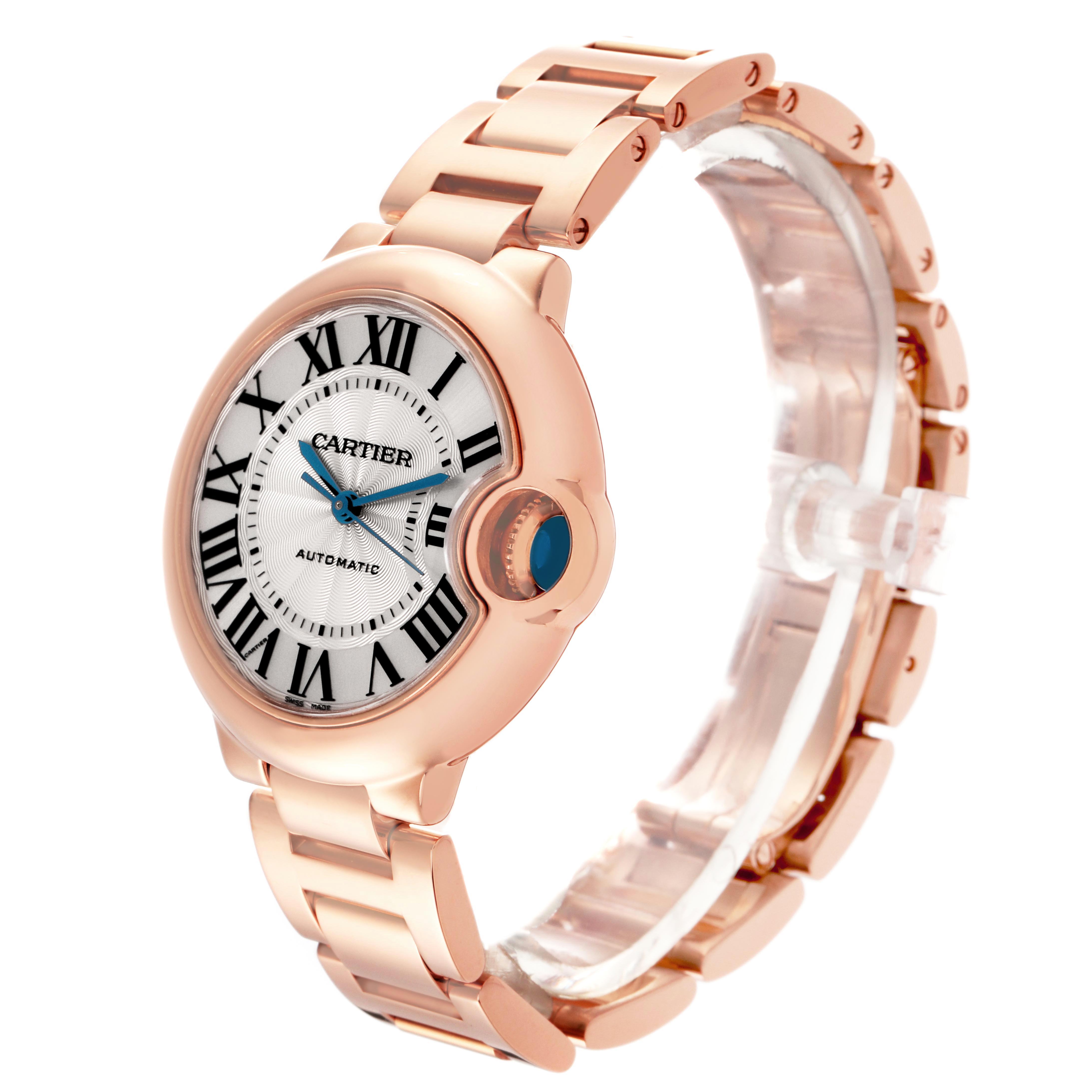 The Cartier Ballon Bleu W6920096 Women's Rose Gold Red Dial W6920096 Women's Rose Gold Red Dial watch is shown at a three-quarter angle, highlighting the face, bracelet, and crown.
