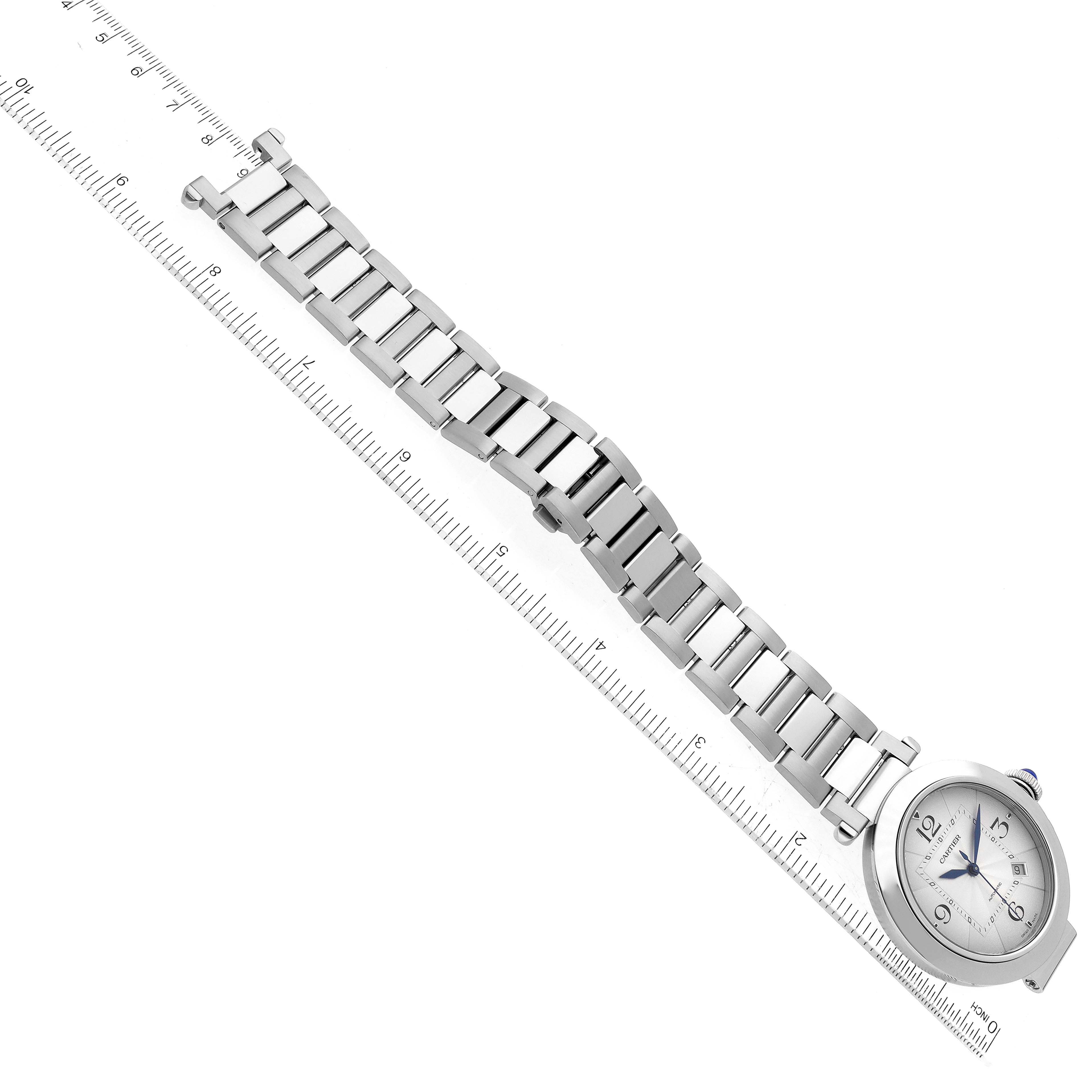The image shows a top-down view of a Cartier Pasha WSPA0009 Men's Stainless Steel Silver Dial WSPA0009 Men's Stainless Steel Silver Dial model watch with its bracelet laid out beside a ruler for measurement.