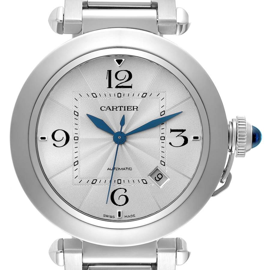 The Cartier Pasha watch is shown from the front, displaying the dial, hour markers, blue hands, and the crown with a blue gem.