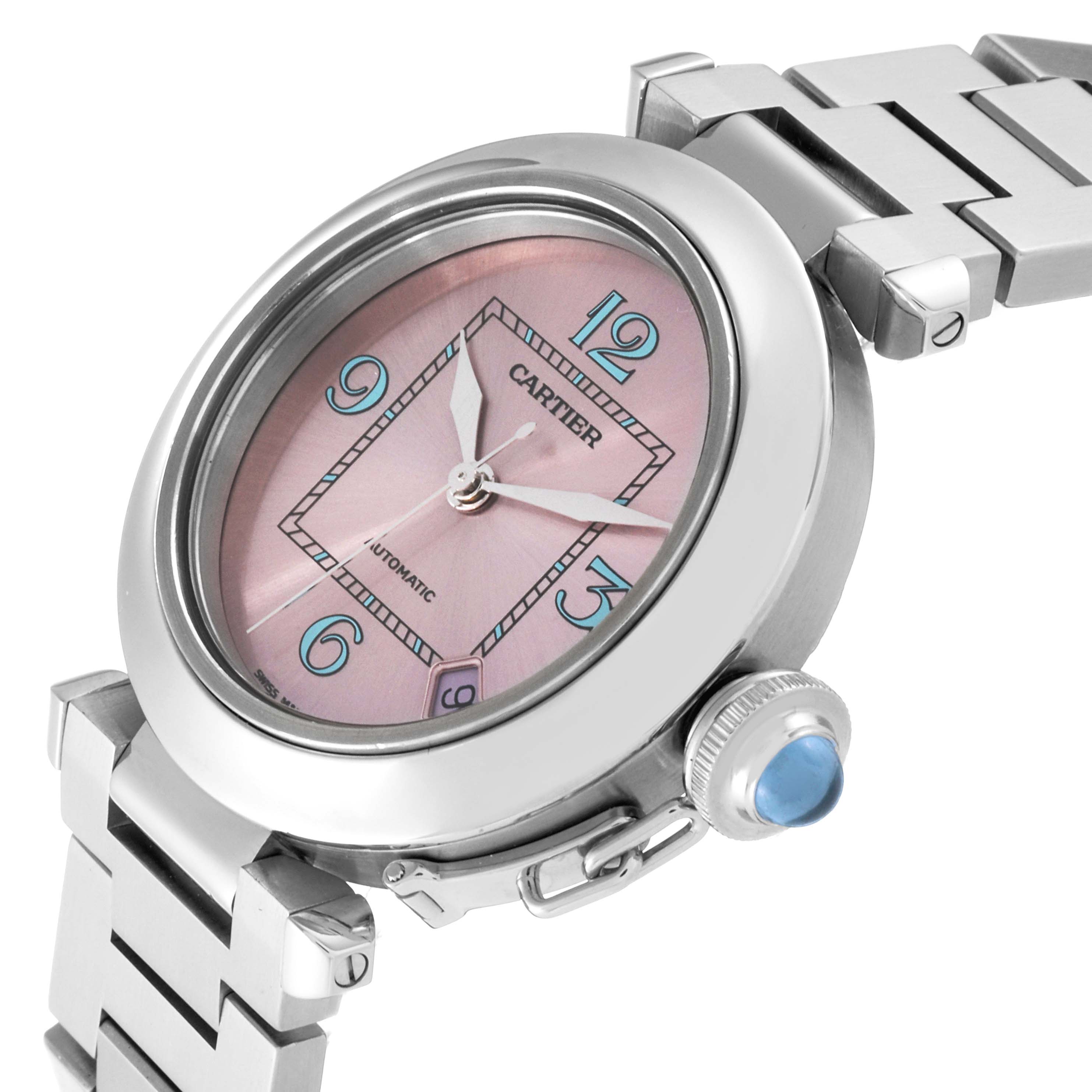 The image showcases a Cartier Pasha W3108199 Women
s Stainless Steel Pink Dial W3108199 Women
s Stainless Steel Pink Dial watch from an angled close-up, highlighting its pink dial, crown, and stainless steel bracelet.