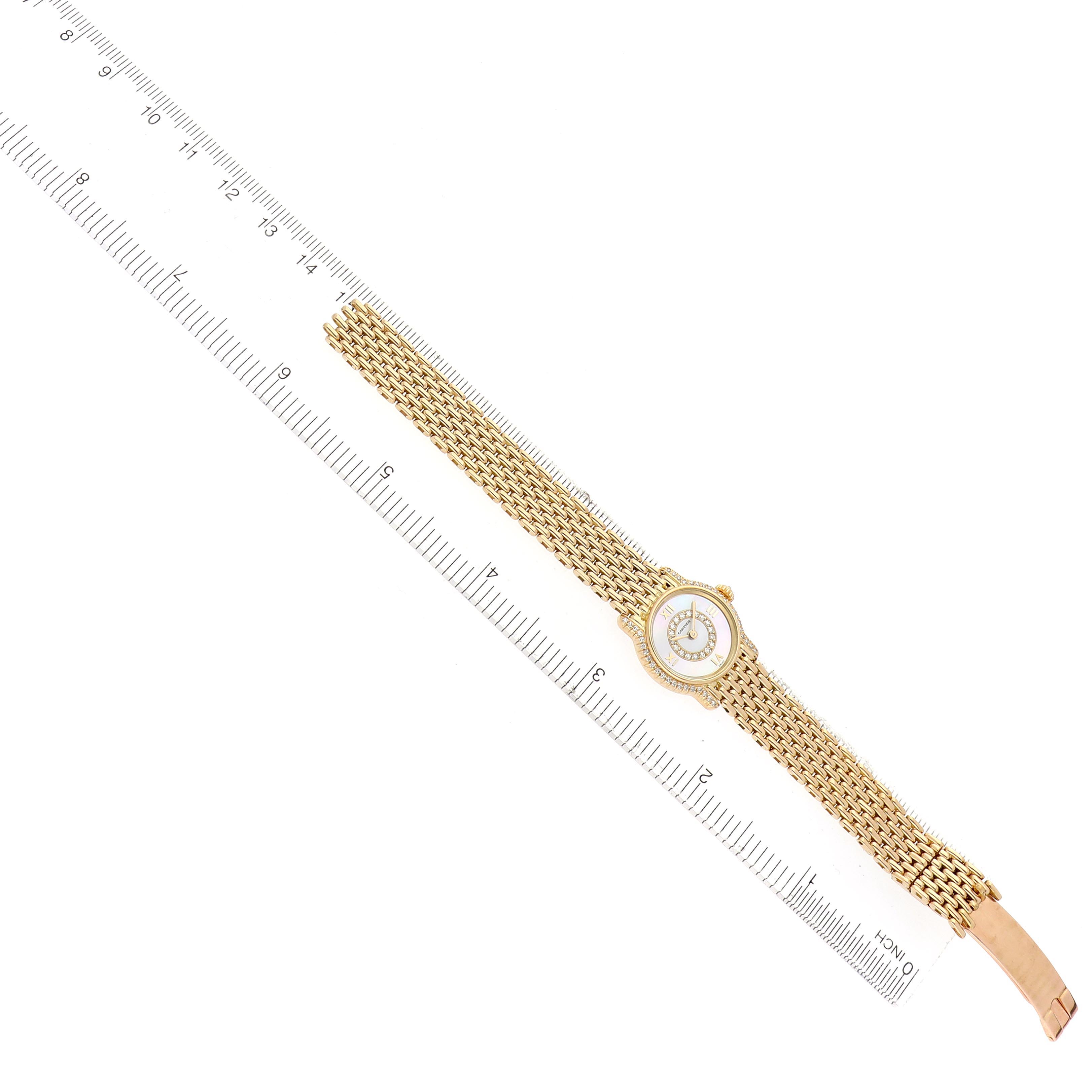 The Cartier Vendome CARTIER RIVIERA SMALL YELLOW GOLD QUARTZ LADIES WATCH BOX PAPERS. Women's Yellow Gold Mother of Pearl Dial CARTIER RIVIERA SMALL YELLOW GOLD QUARTZ LADIES WATCH BOX PAPERS. Women's Yellow Gold Mother of Pearl Dial watch is shown from a top-down angle, displaying its face, bezel, and gold mesh strap alongside a ruler.