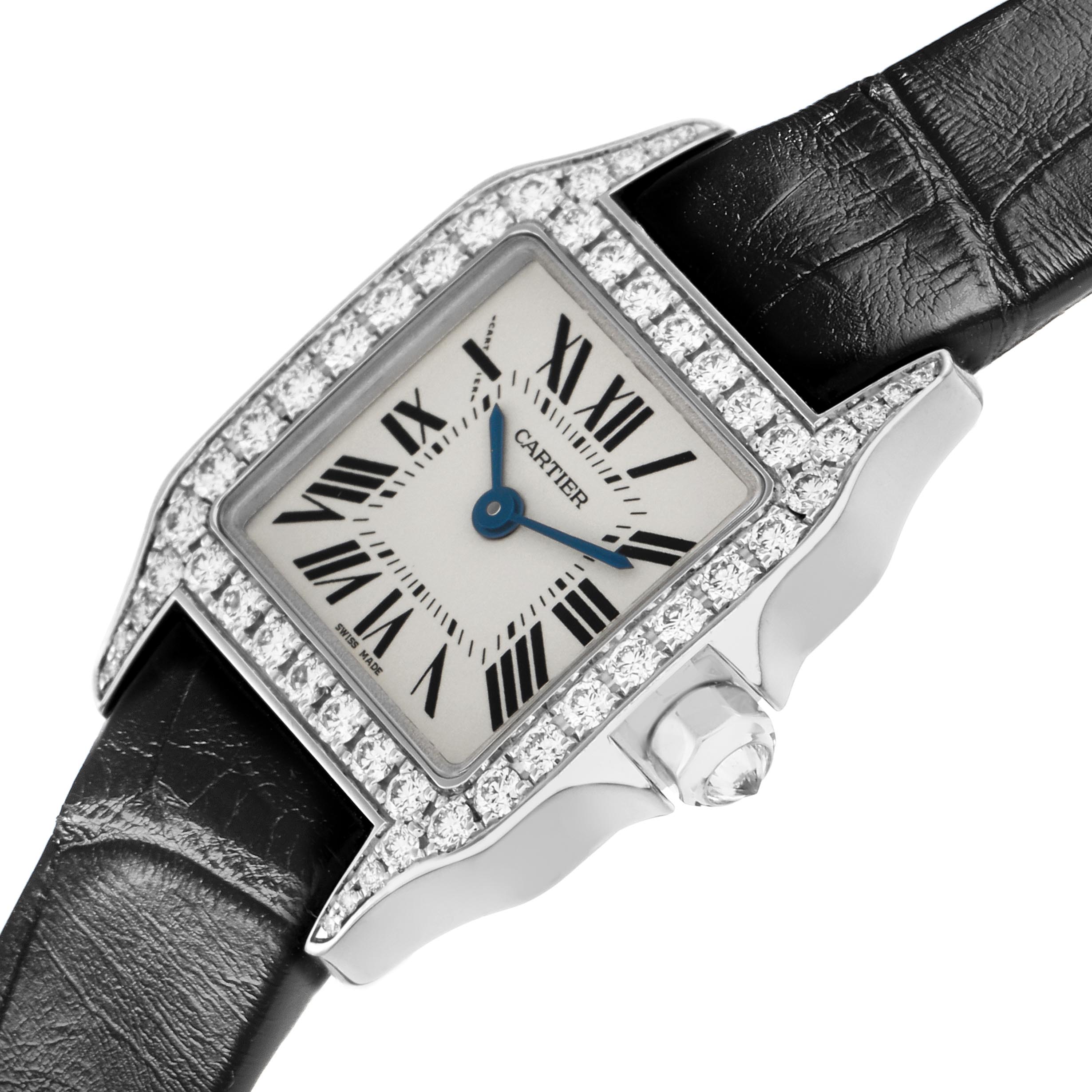 The Cartier Santos Demoiselle WF9005Y8 Women's White Gold Silver Dial WF9005Y8 Women's White Gold Silver Dial watch is shown at an angle highlighting the diamond-set bezel, Roman numeral dial, and crown detail.