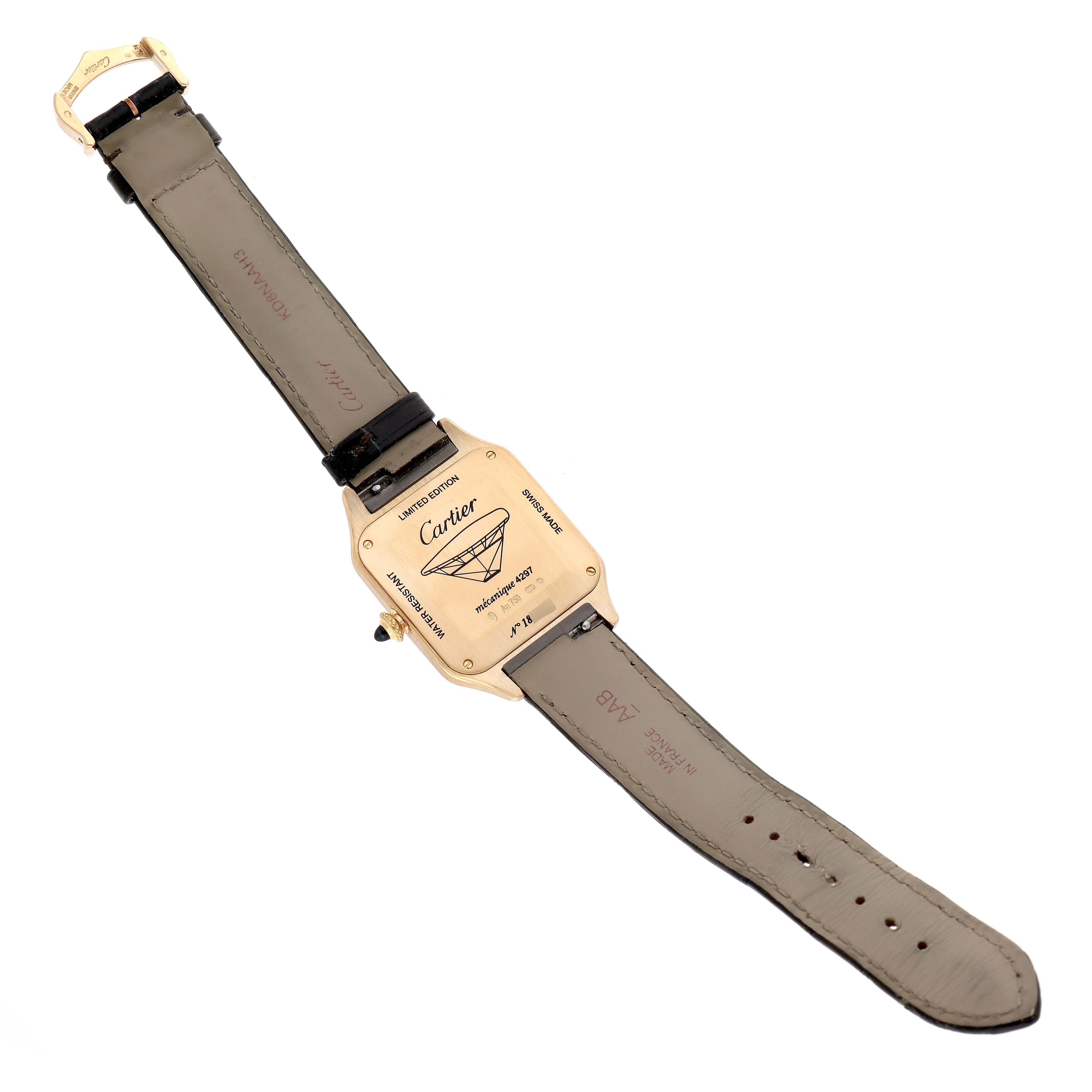 The image shows the back view of a Santos Dumont model watch by Cartier, revealing the case back and leather straps.